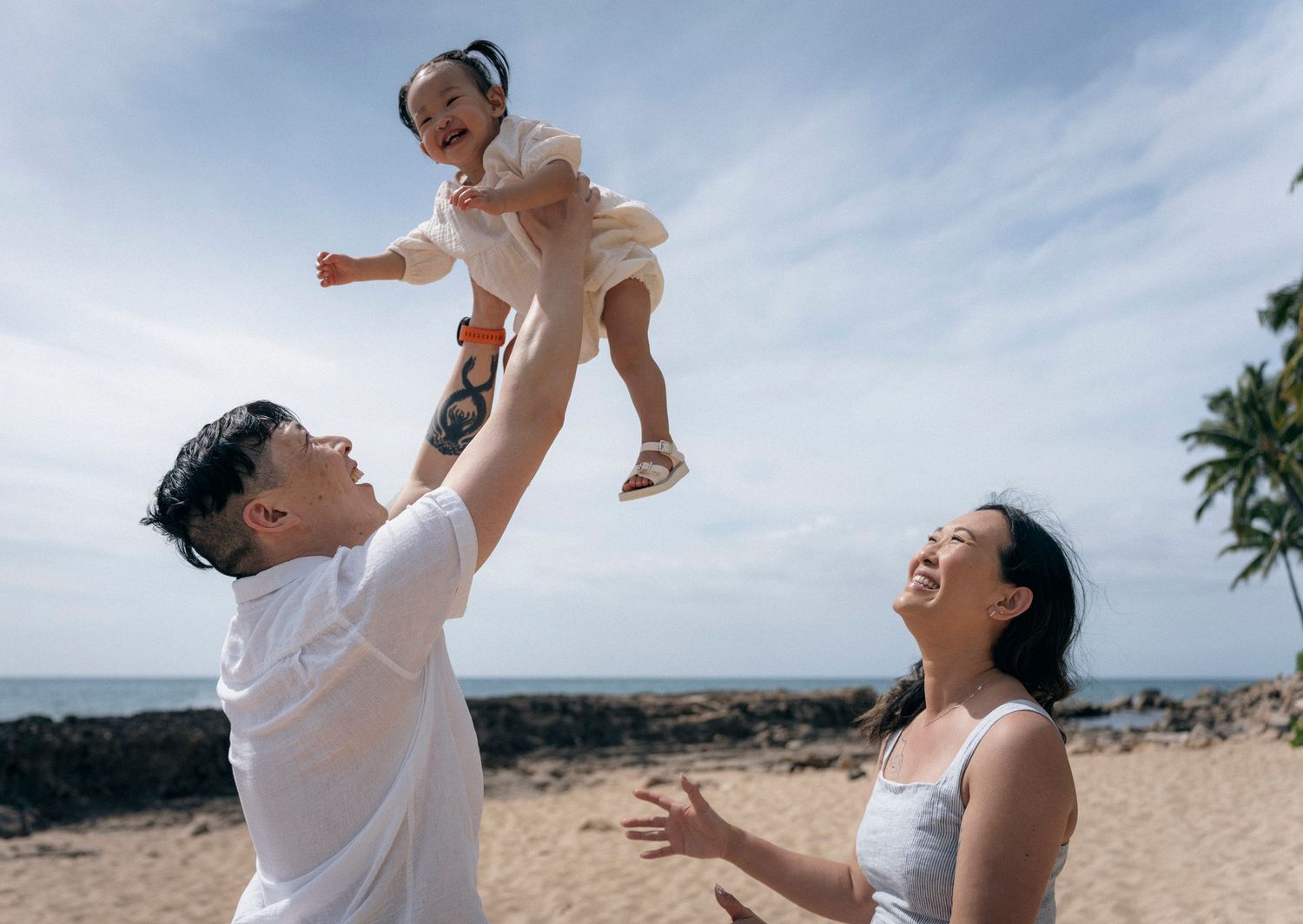 Joyful moments captured on a sunny beach with palm trees in background.