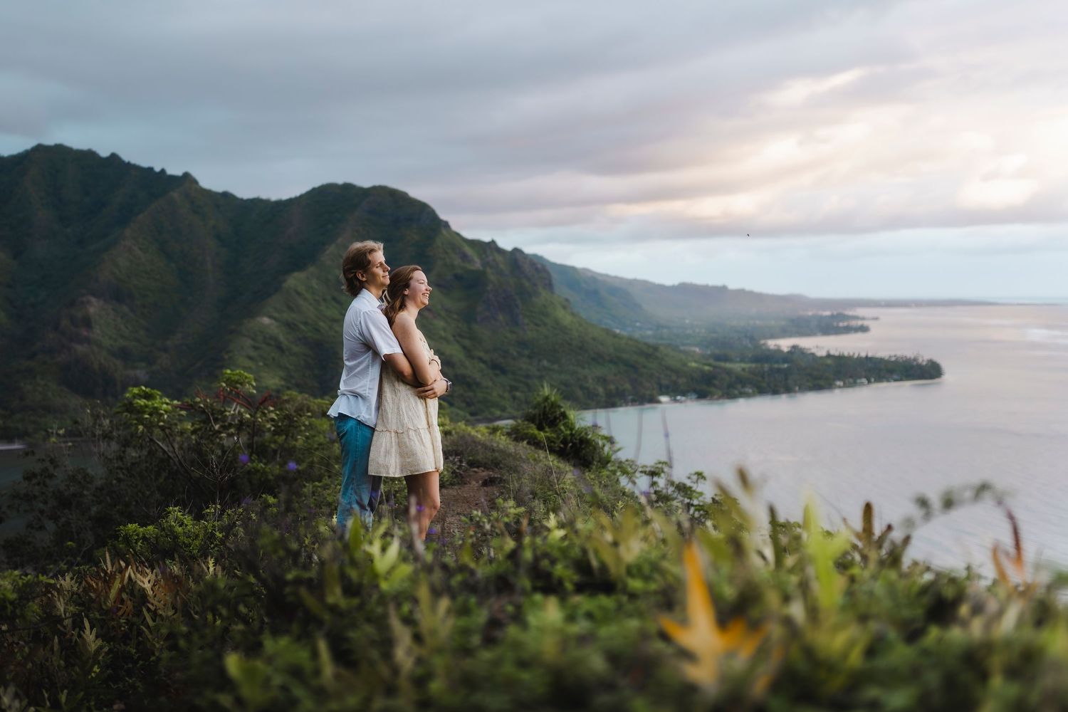 A scenic mountain coastline view in Hawaii with dramatic clouds and ocean vistas.