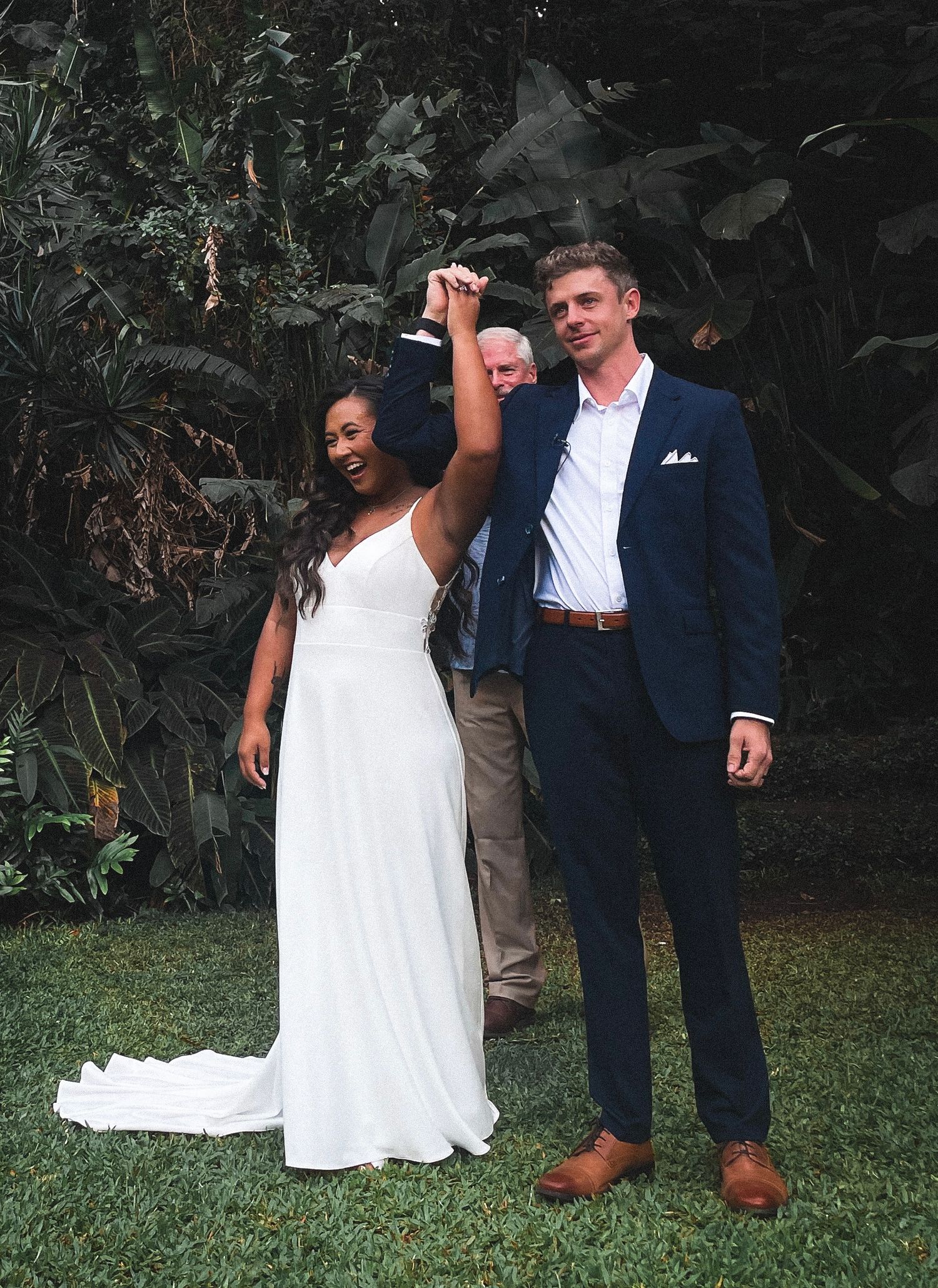 Wedding celebration in a tropical garden setting with elegant wedding attire In Hawaii.