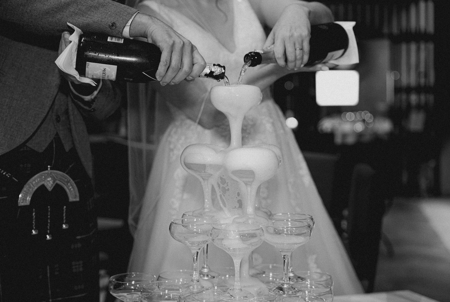 A series of black and white photos showing hands pouring drinks and mixing cocktails at a bar.