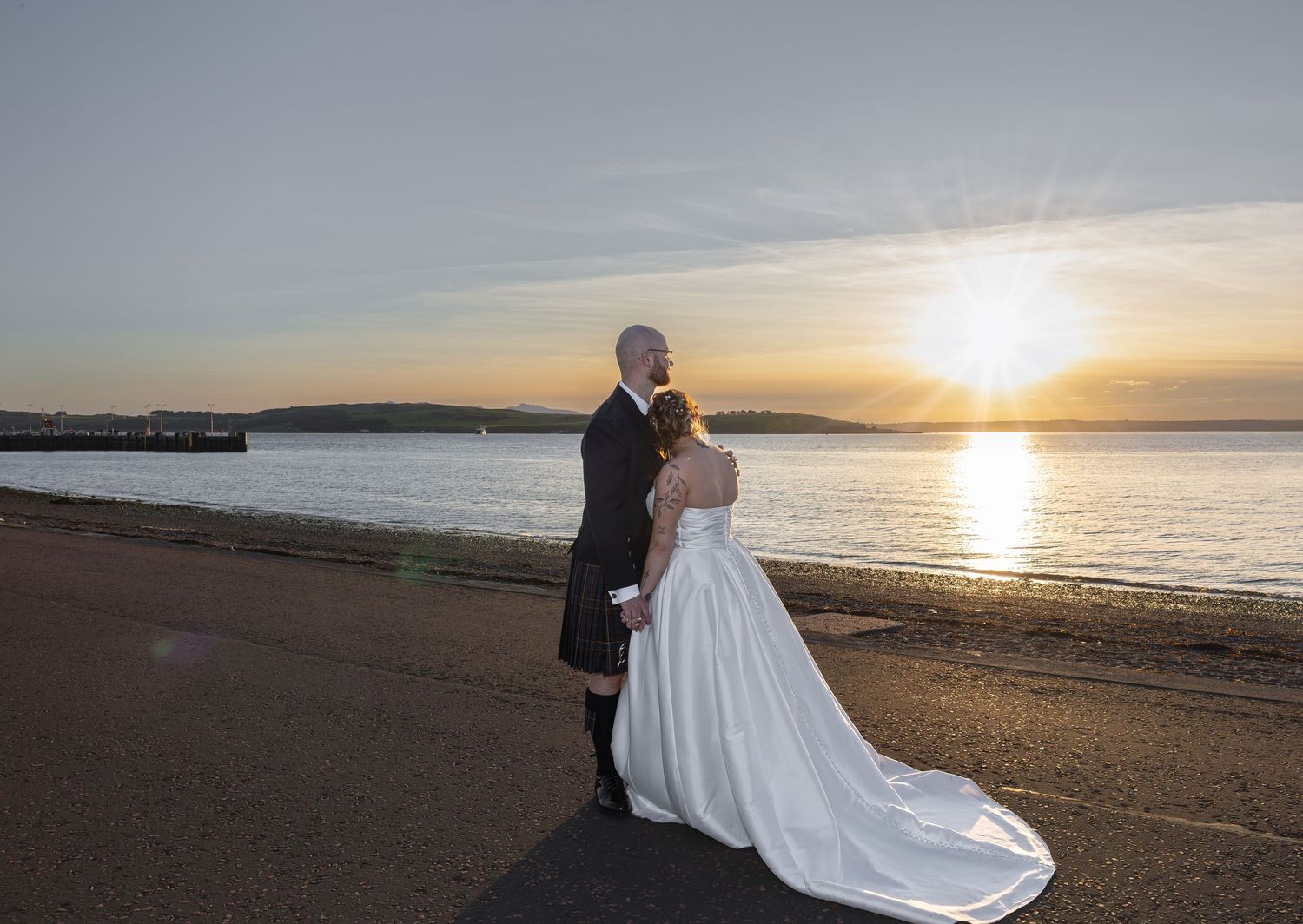 Wedding photography session on beach at sunset with dramatic ocean backdrop. Ayrshire Wedding