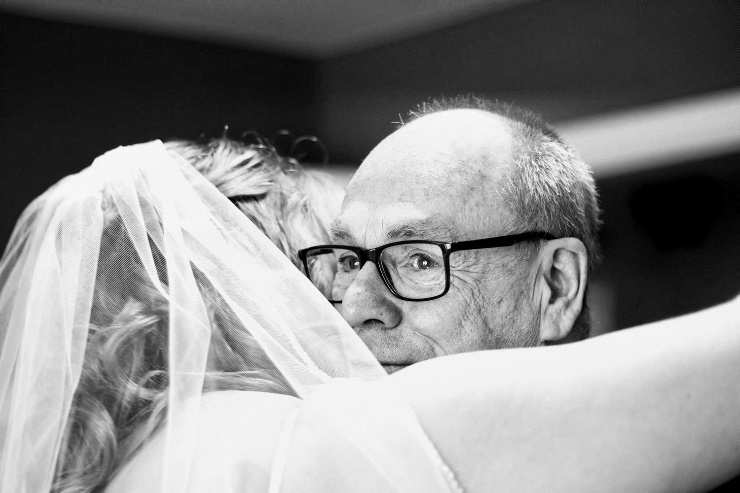 An intimate black and white wedding portrait capturing a close-up emotional moment. Broxburn