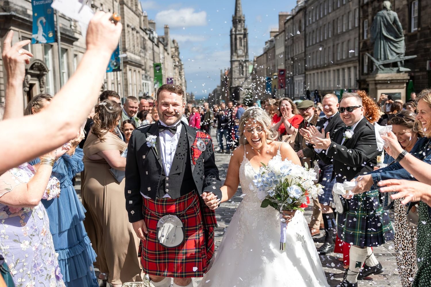 Wedding celebration on Edinburgh's Royal Mile with confetti and traditional Scottish attire. Royal Mile , Edinburgh City Chambers