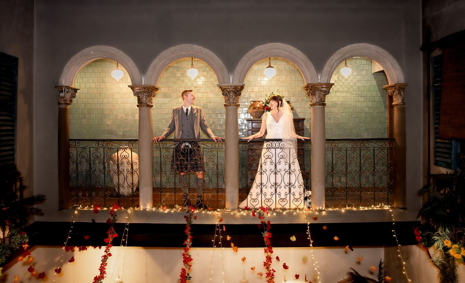 A panoramic view of a wedding ceremony in an elegant church sanctuary with arched columns and decorative candles.