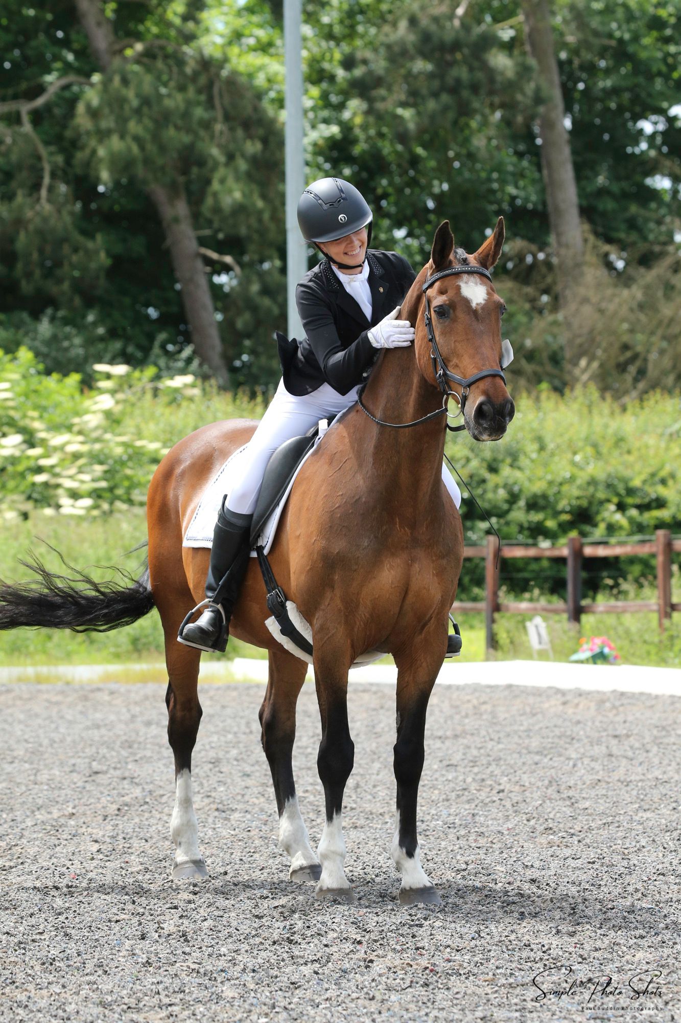 Emily Prouse the Photographer at dressage competition, with late horse Rocky performing their final halt salute and pat in outdoor arena.
