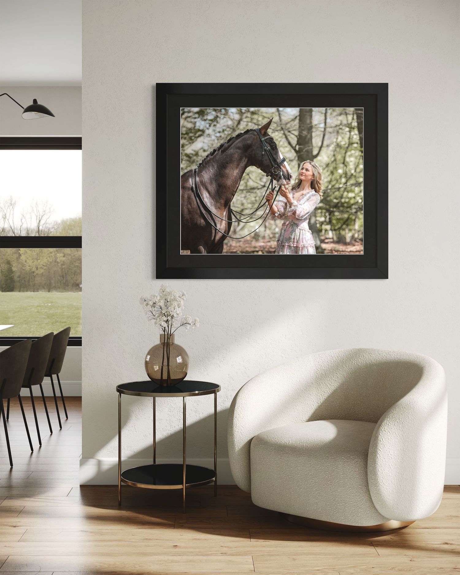 Modern minimalist living room with white chairs and framed equestrian artwork. Clean cream walls and signature Black frame style for luxury.