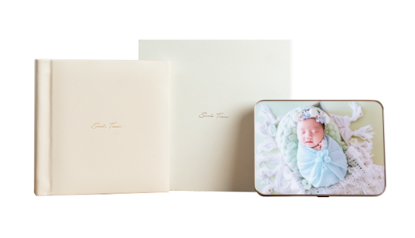 Elegant cream leather photo album with matching keepsake box featuring a newborn baby portrait, perfect for birth photography.