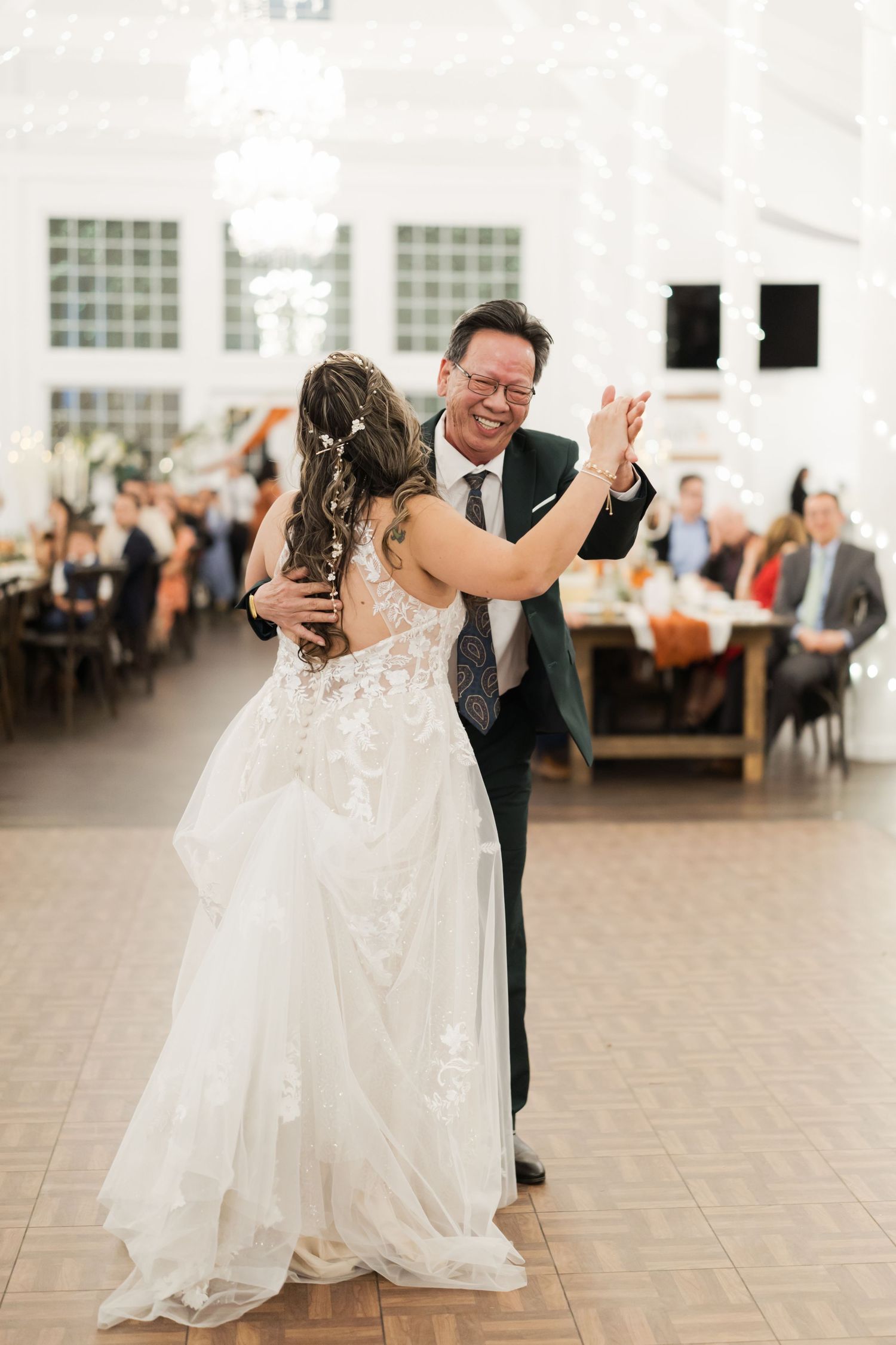Wedding couple dancing together at their reception in an elegant venue.