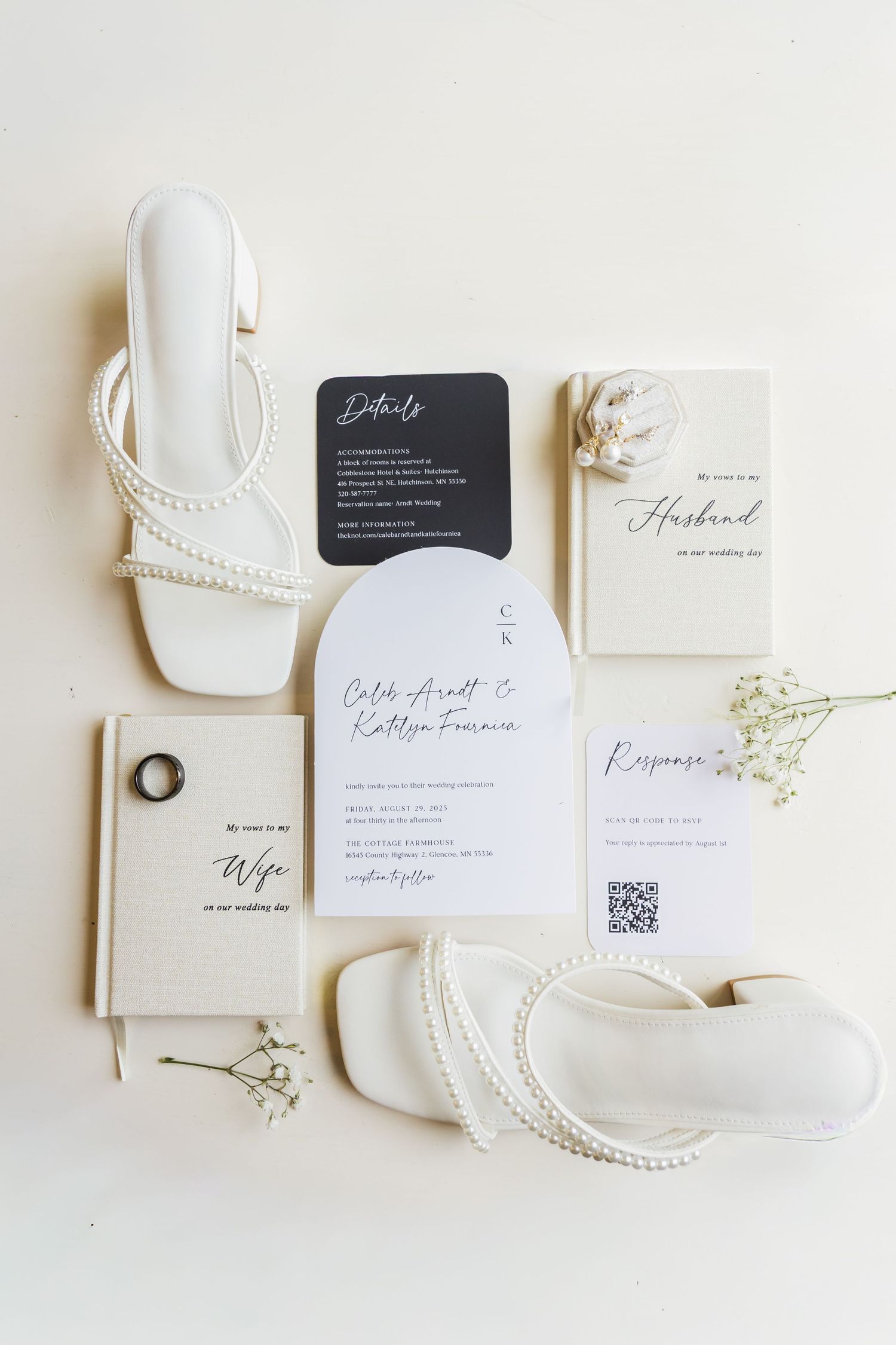 Elegant wedding stationery flatlay with white shoes, invitations and baby's breath flowers.