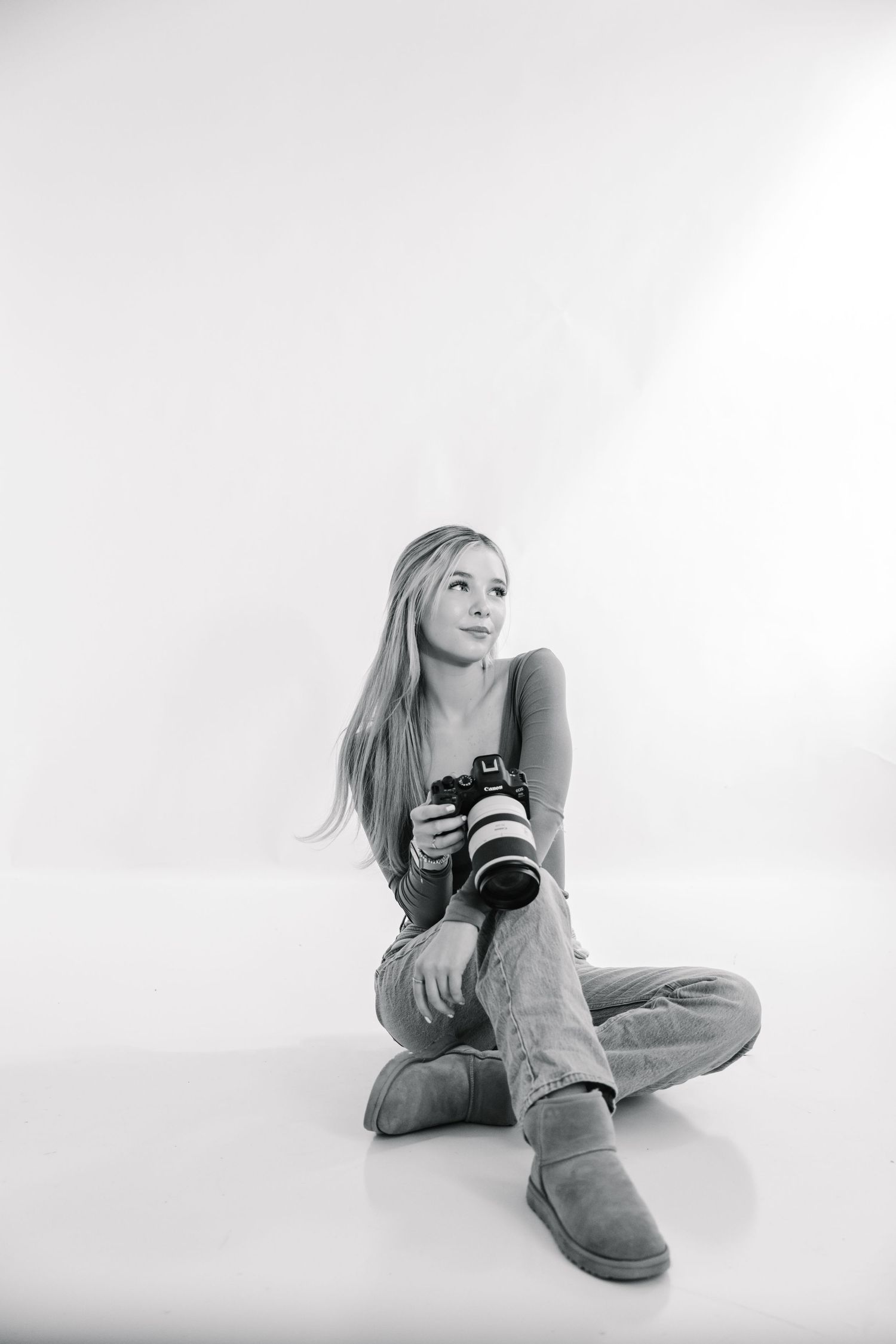 Black and white portrait series showing casual poses with camera equipment.