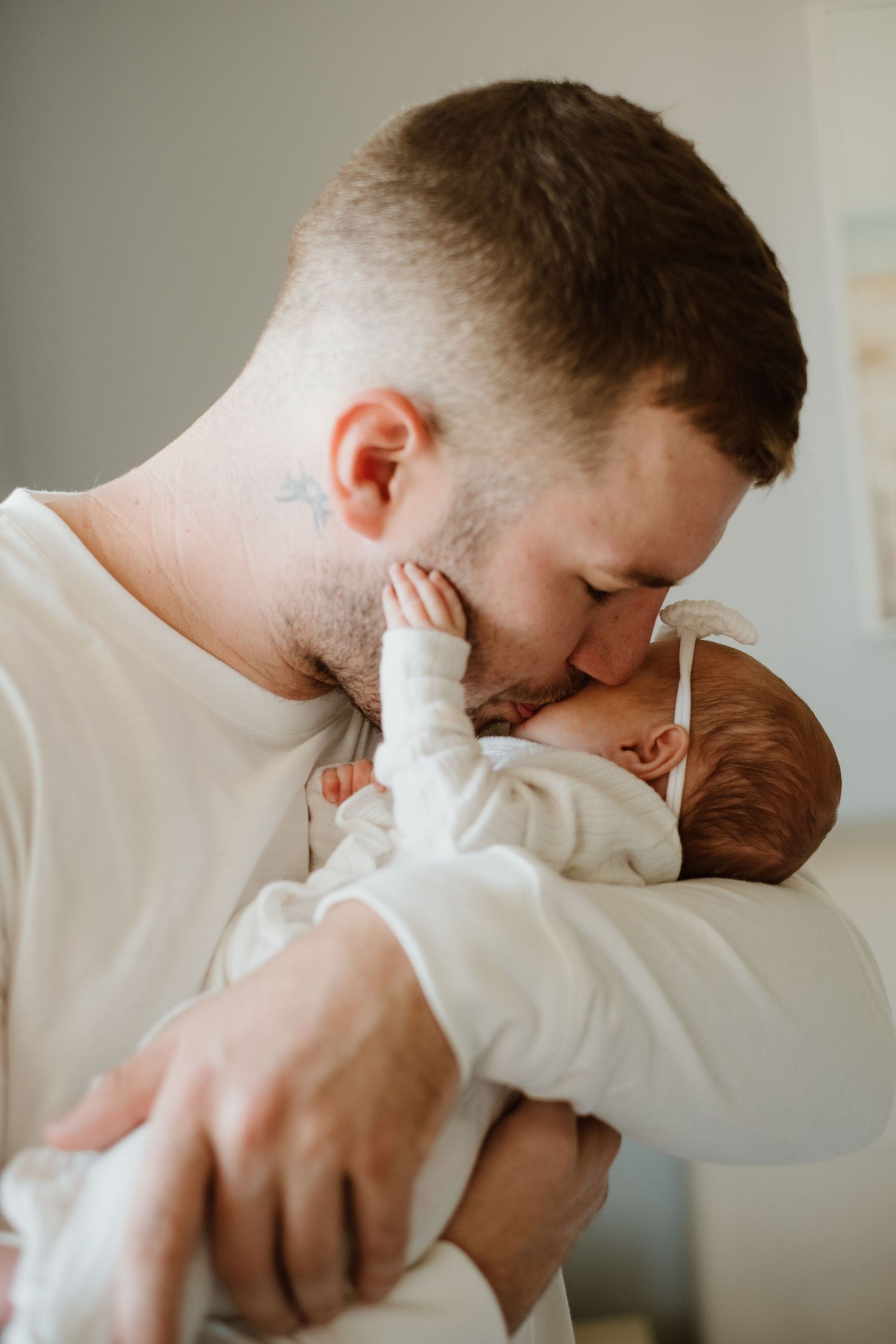 Intimate newborn moment showing gentle care and affection.
