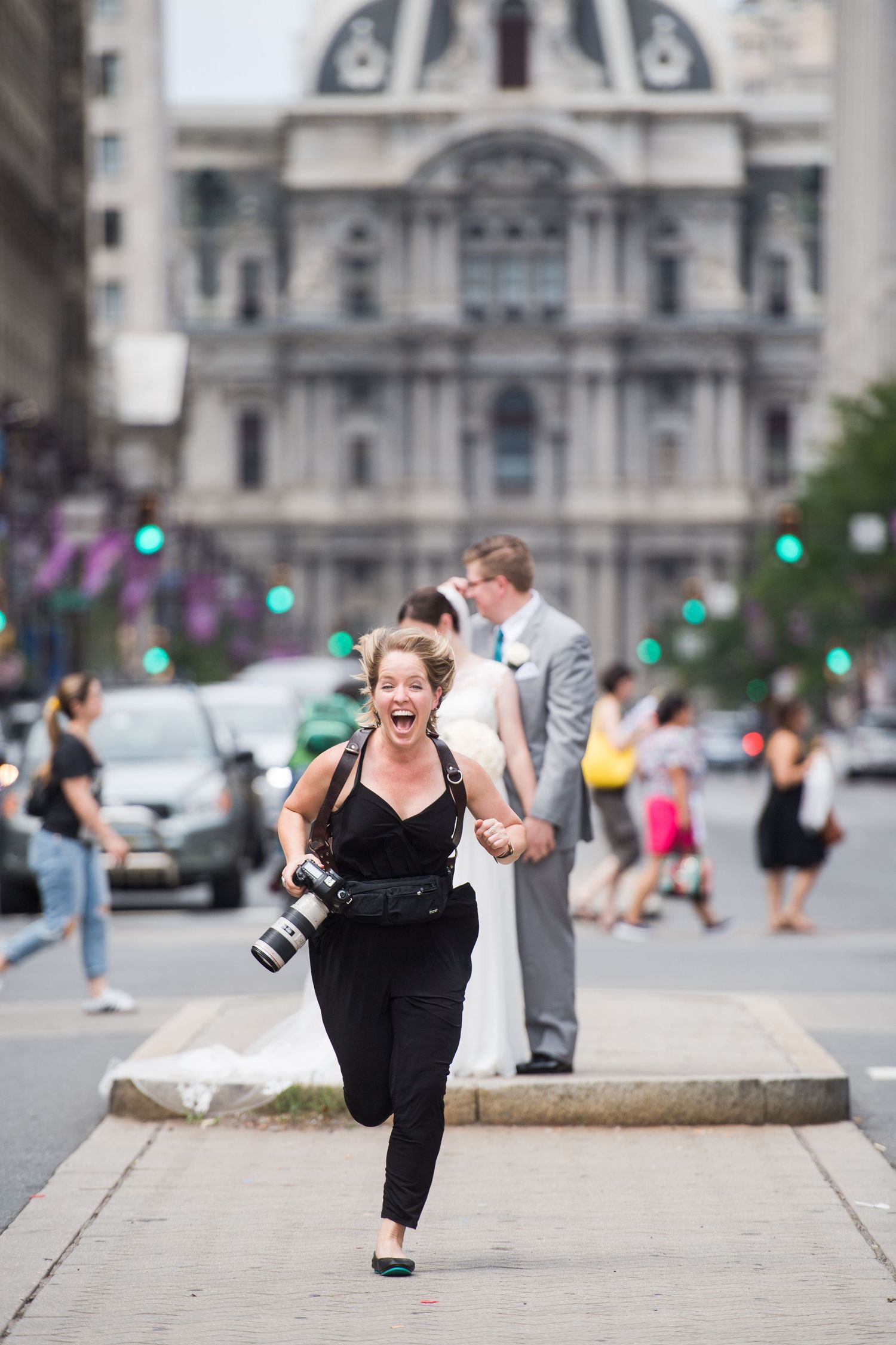 Camera equipment and photography gear arranged on a city street with historic architecture.