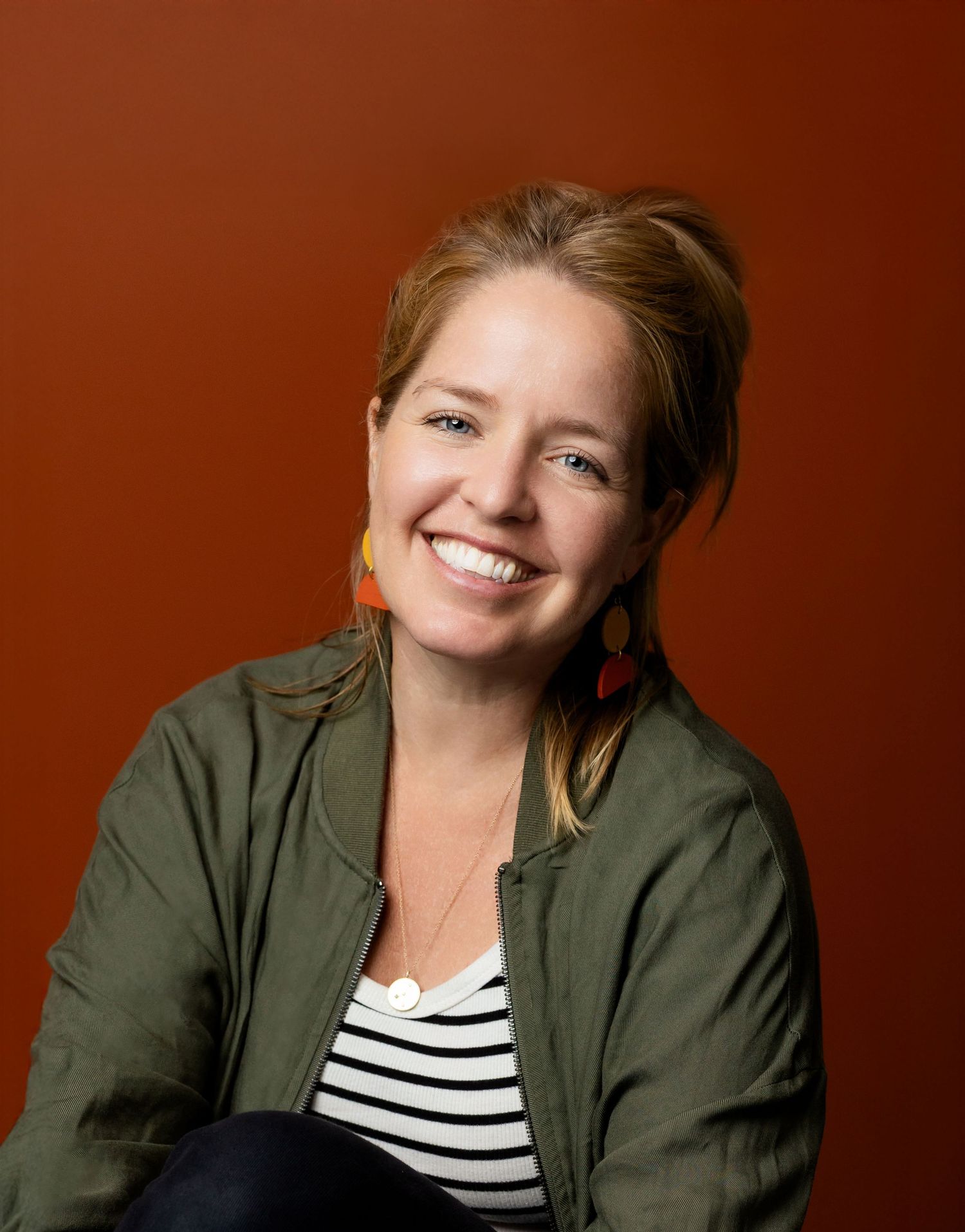 Portrait series showing different poses and expressions against a deep red background.