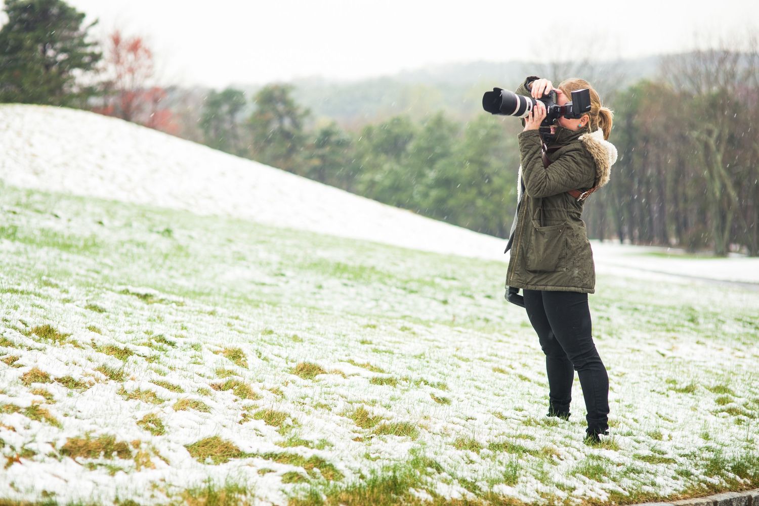 Professional photographers capturing shots in a snowy winter landscape.