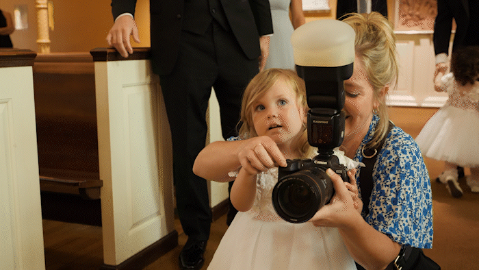 behind the scenes of photographer giving a high five to a child