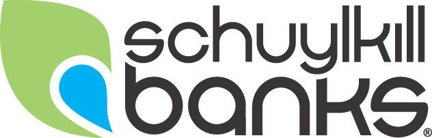 Schuylkill Banks logo featuring a green and blue leaf icon beside bold typography on a white background.