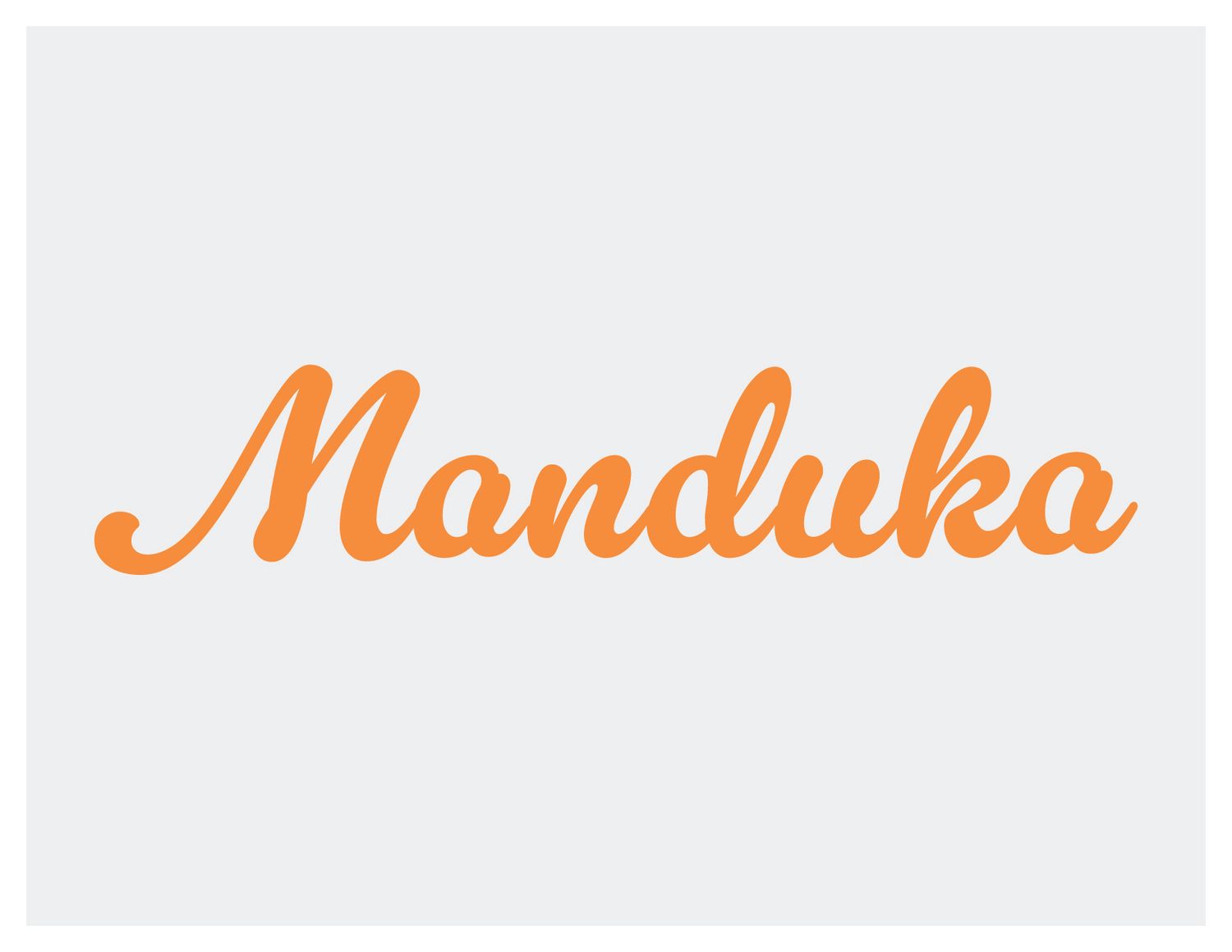 Manduka brand logo in orange cursive script on light gray background.