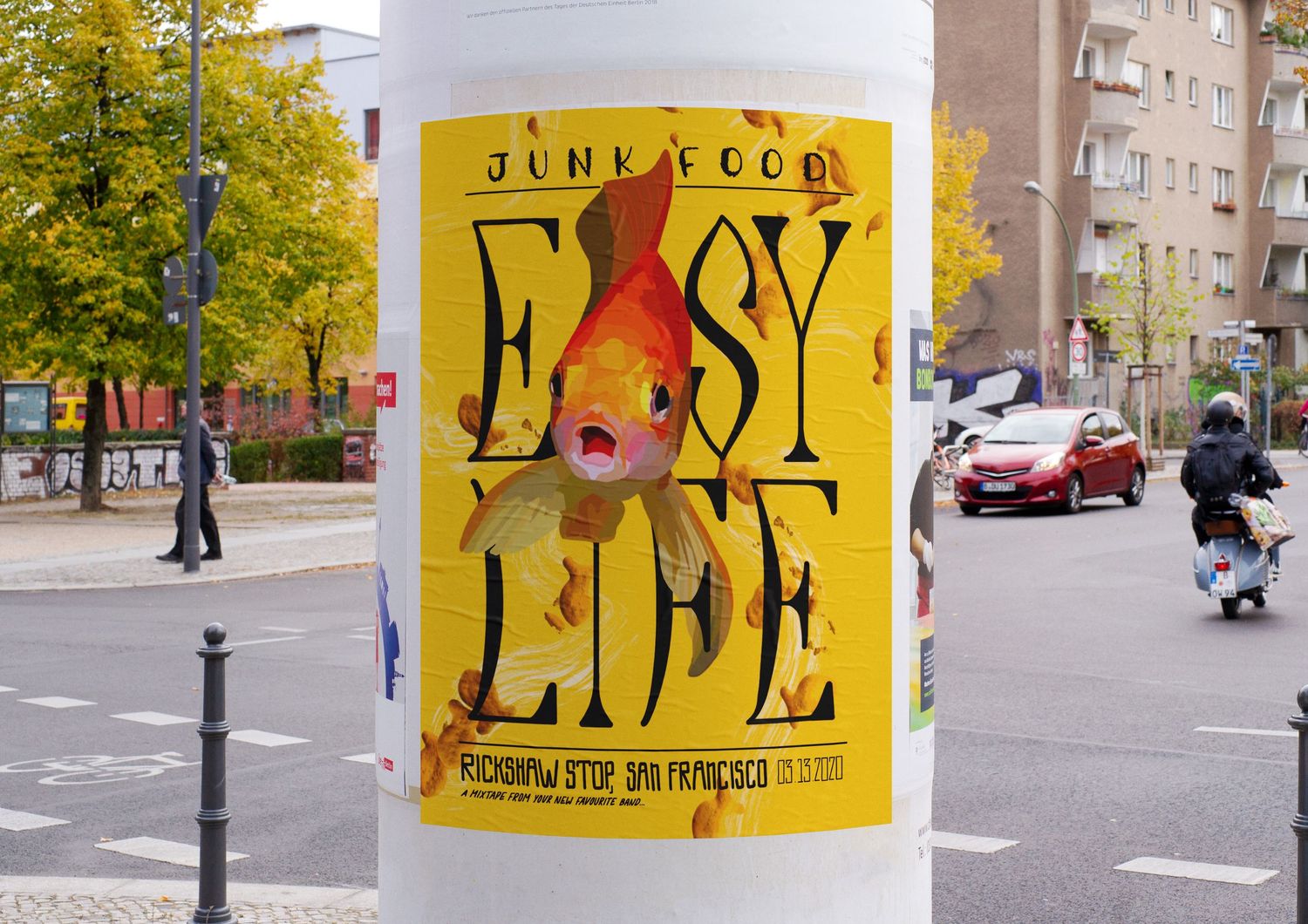 Easy Life Junk Food band poster wheatpasted on urban street pole with goldfish graphic design.