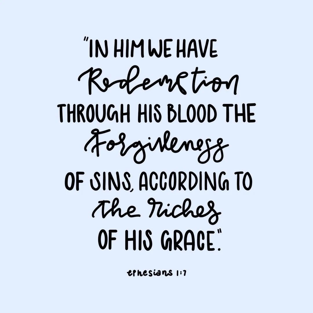 Light blue card with hand-lettered Ephesians 1:7 Bible verse about redemption and forgiveness in black ink.