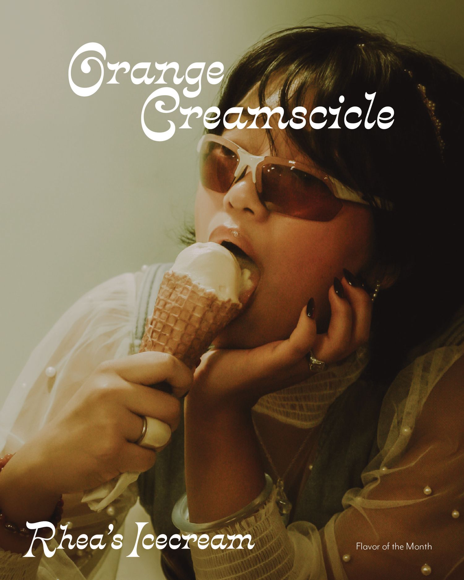 Woman licking Orange Creamsicle ice cream cone in waffle cup, Rhea's Icecream Flavor of the Month ad.