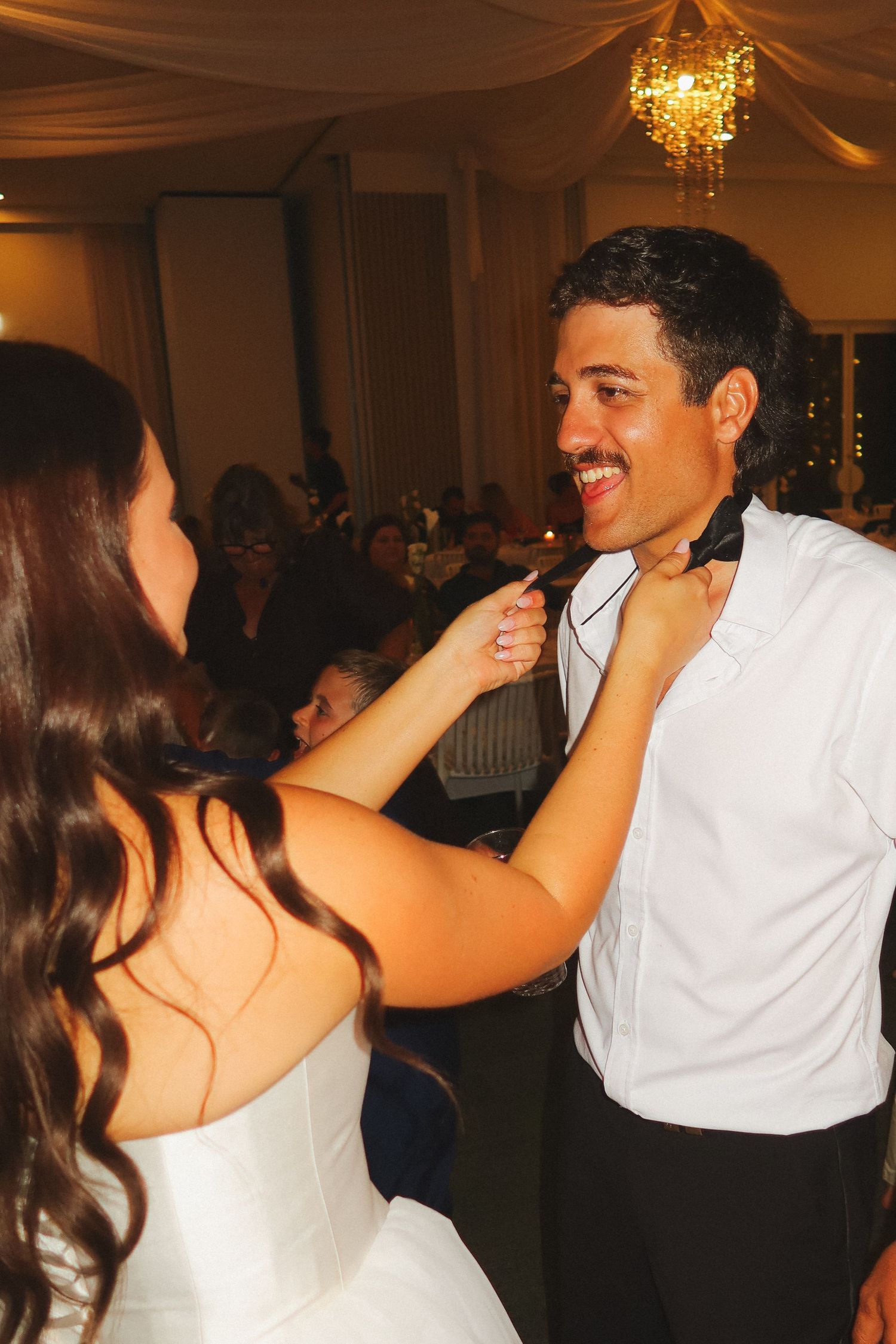 Bride and groom sharing a joyful first dance at their wedding reception.
