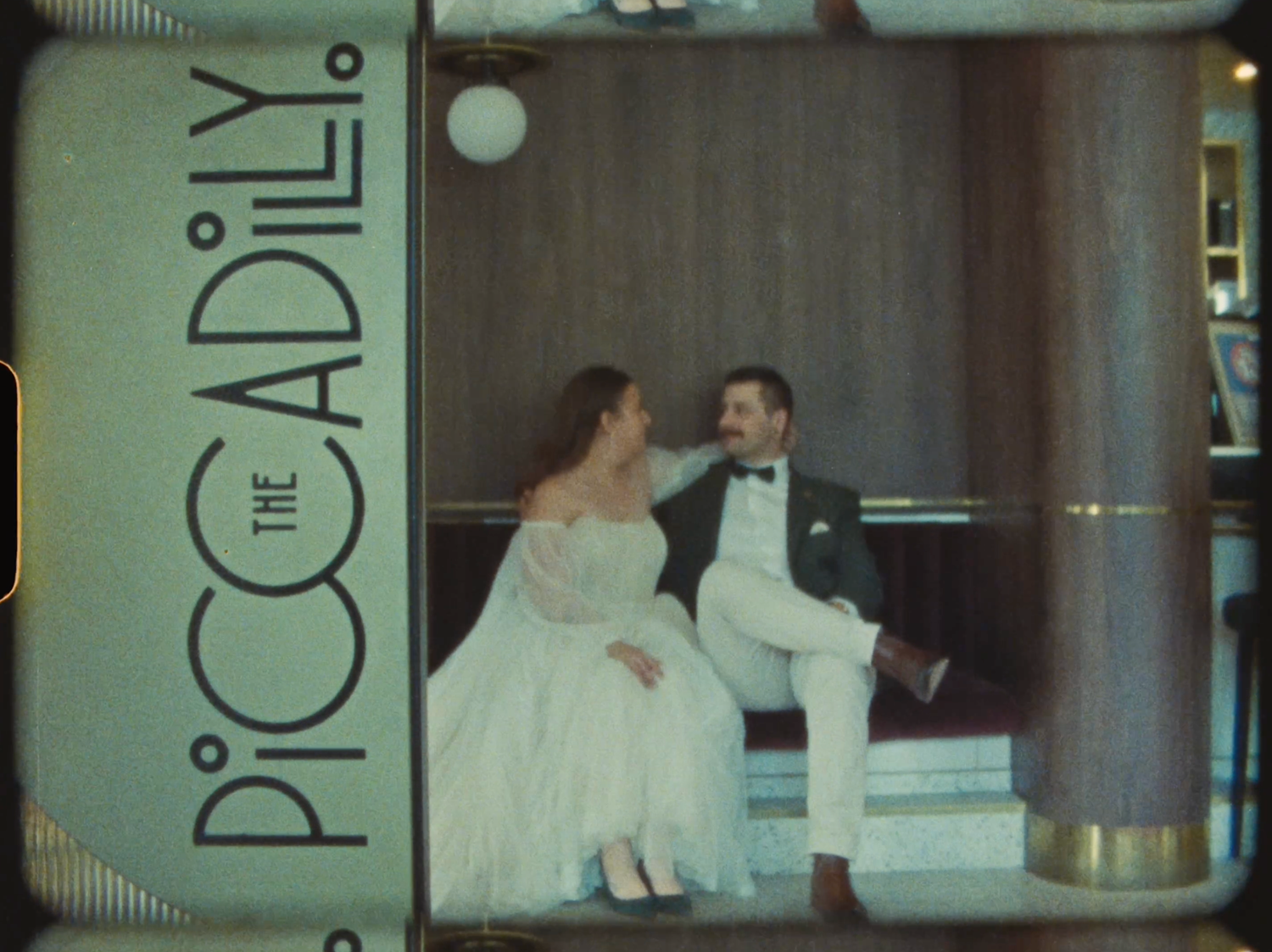 Bride and groom posing elegantly at The Piccadilly venue in vintage wedding photo.