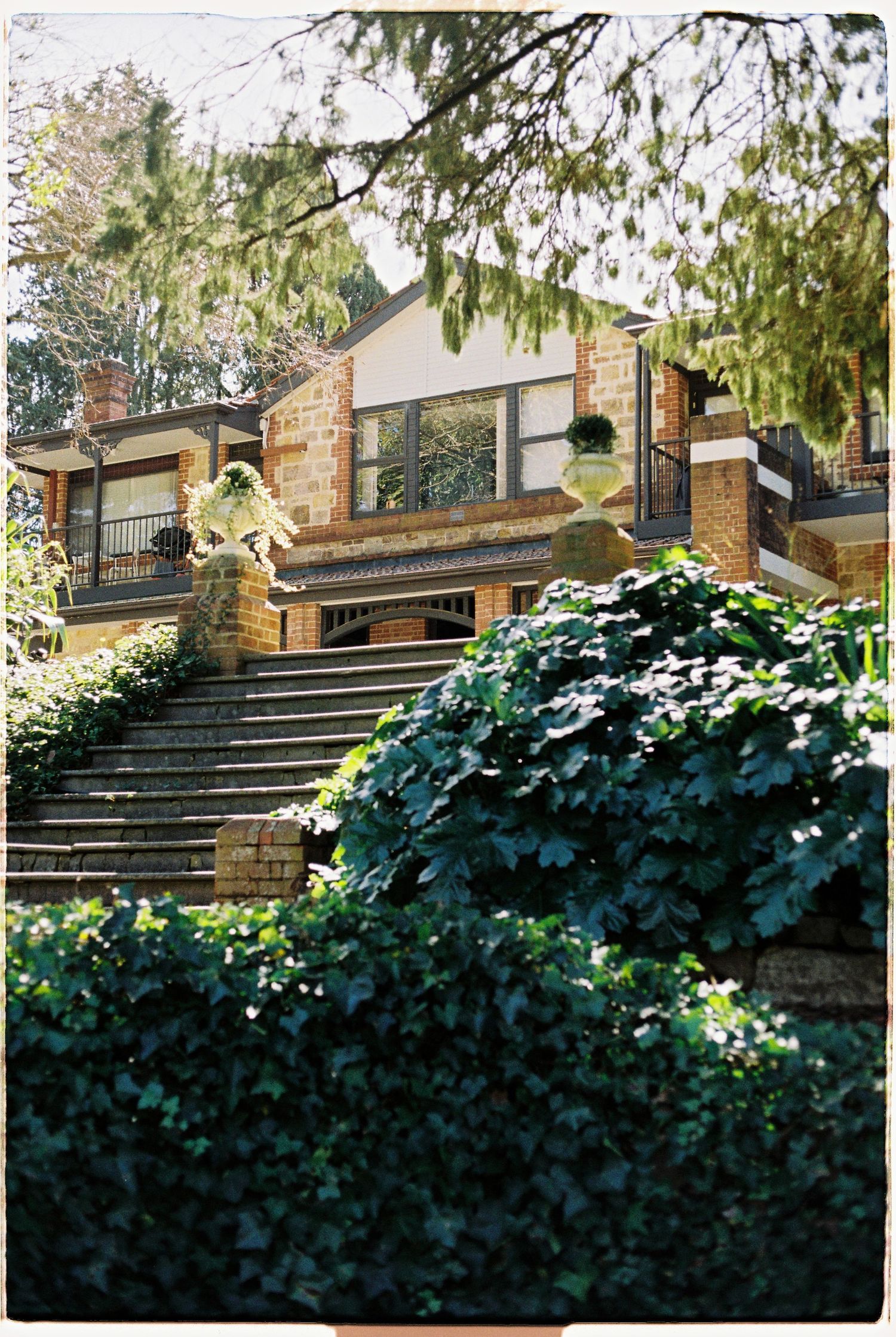 Stone and brick venue with ivy-covered steps and lush garden surroundings.