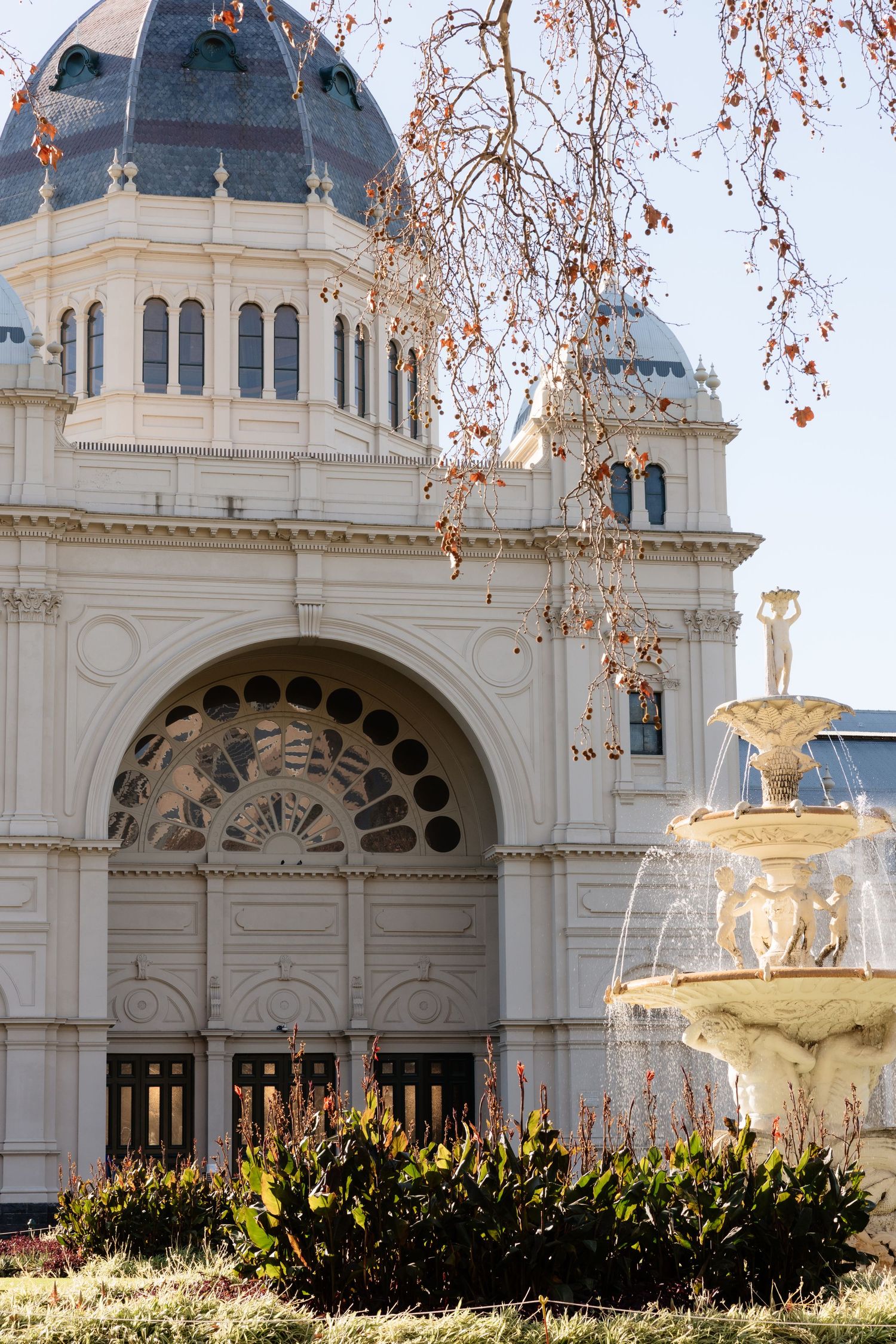 Royal Exhibition Building facade with ornate fountain in foreground, Melbourne, Australia.