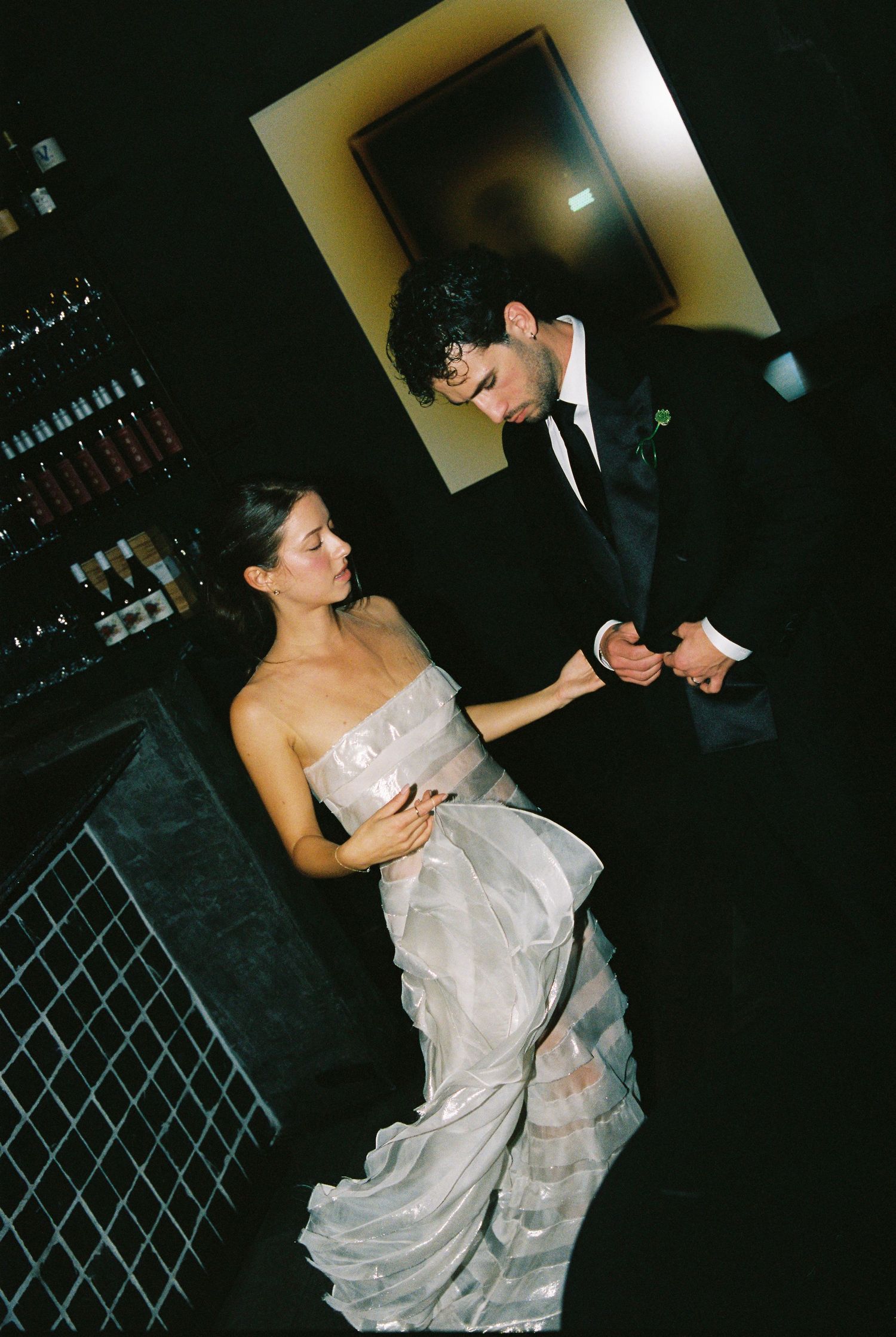 Bride and groom sharing an intimate dance moment near a wine cellar at their wedding.