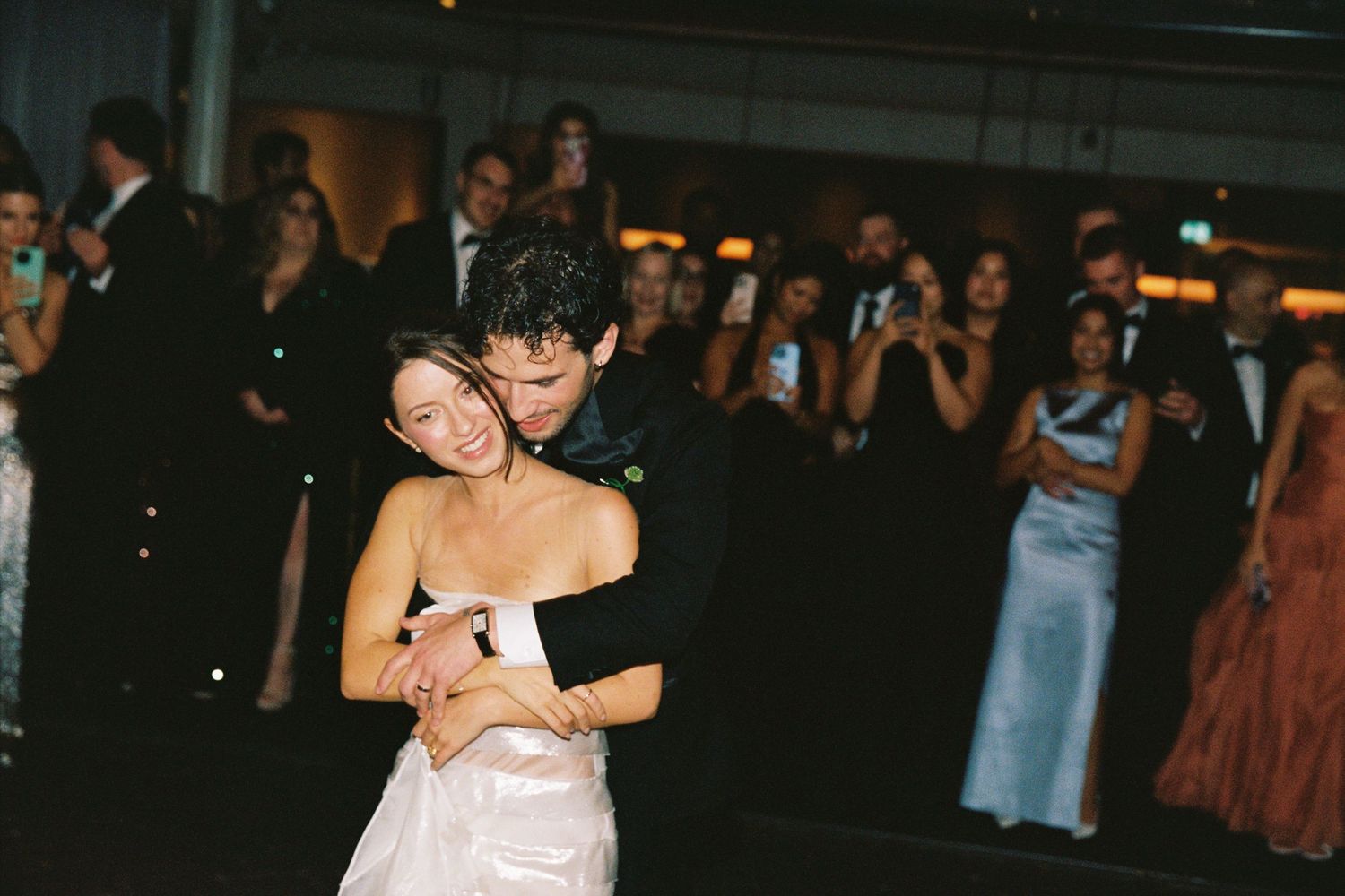 Bride and groom share an intimate first dance embrace at their wedding reception.