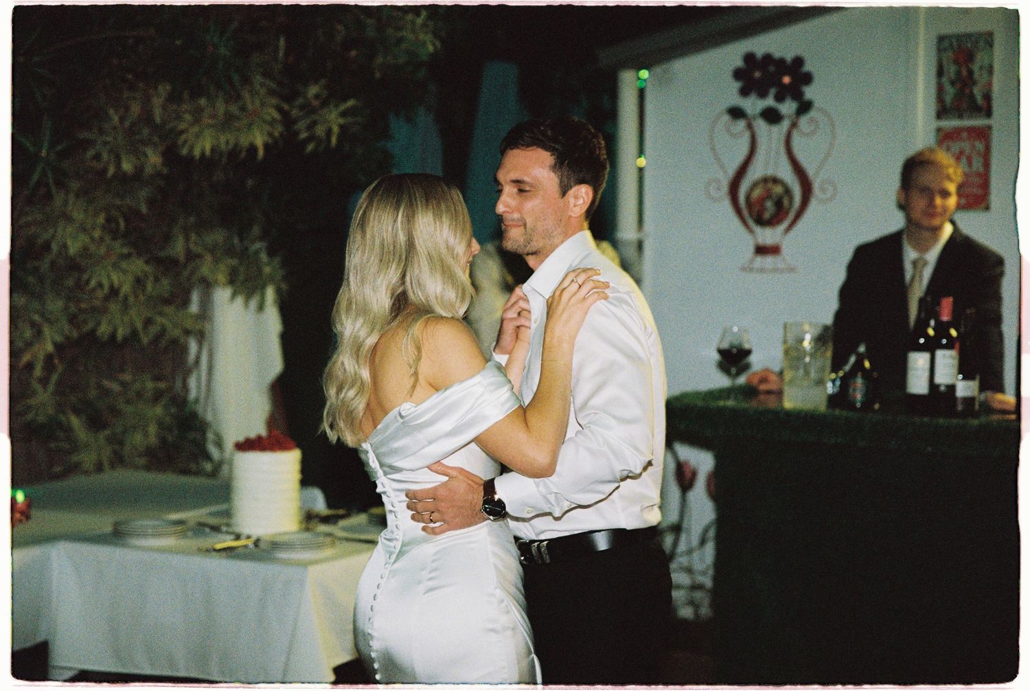 Bride and groom share their first dance at an intimate indoor wedding reception venue.