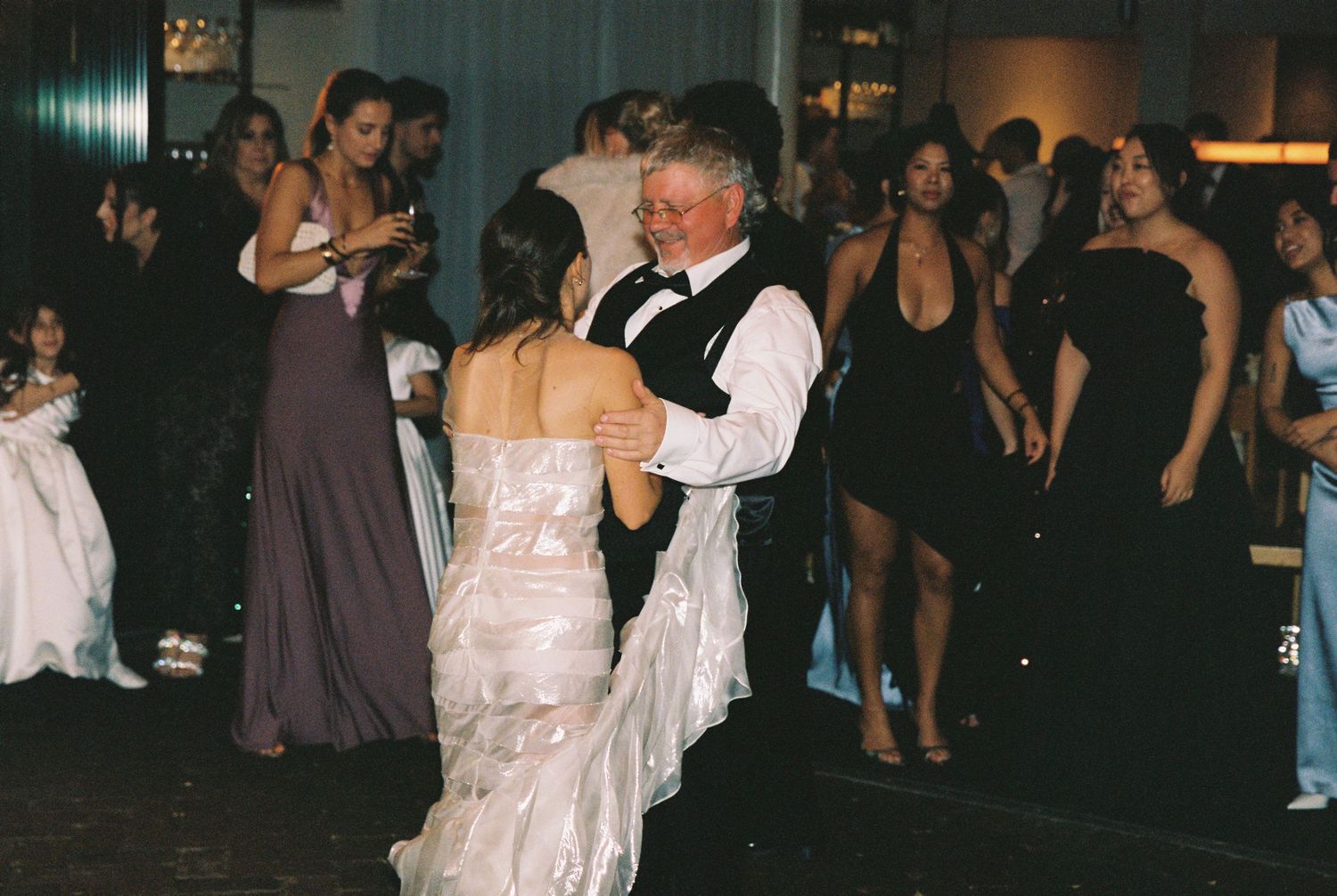 Bride sharing a father-daughter dance at an elegant wedding reception.