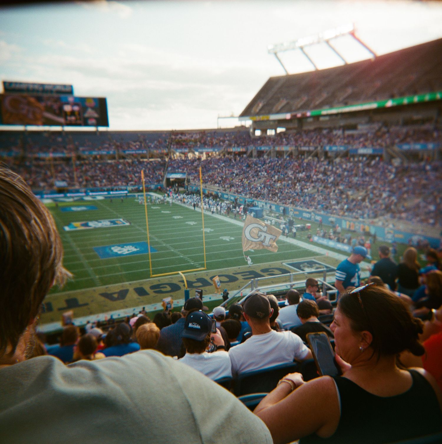 Aerial view of packed football stadium during Georgia Tech game shot on film camera.