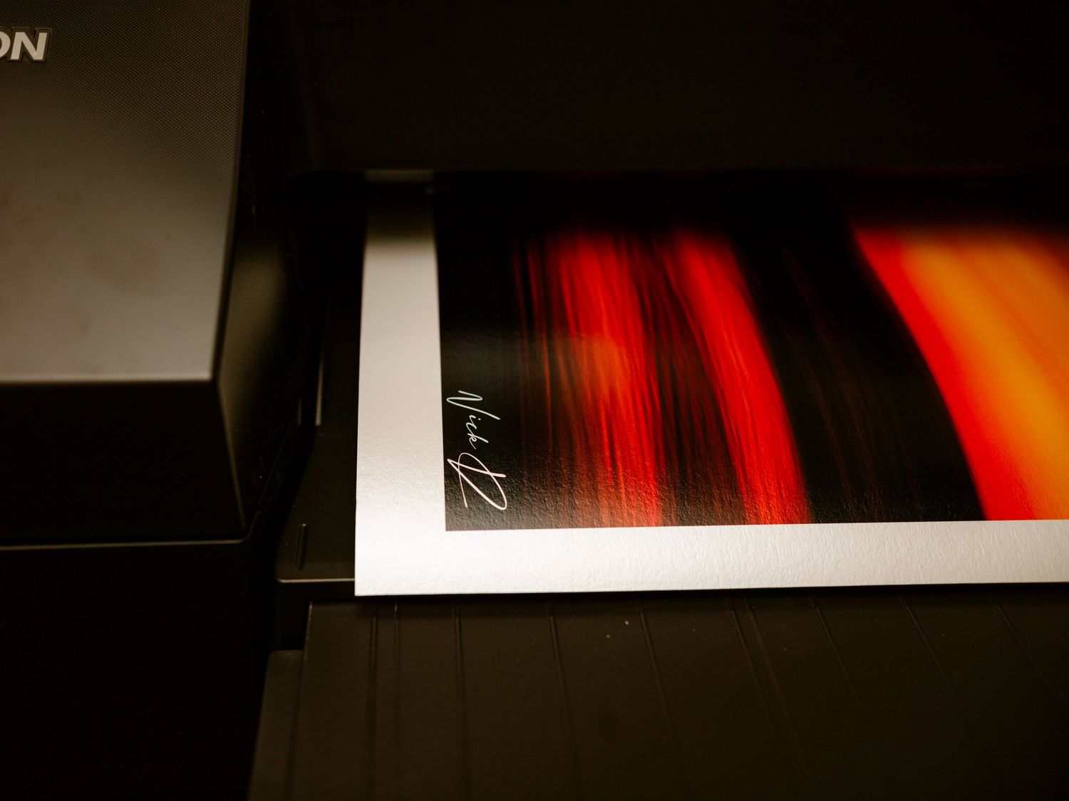 Signed fine art print of an abstract sunset emerging from an Epson large format printer.