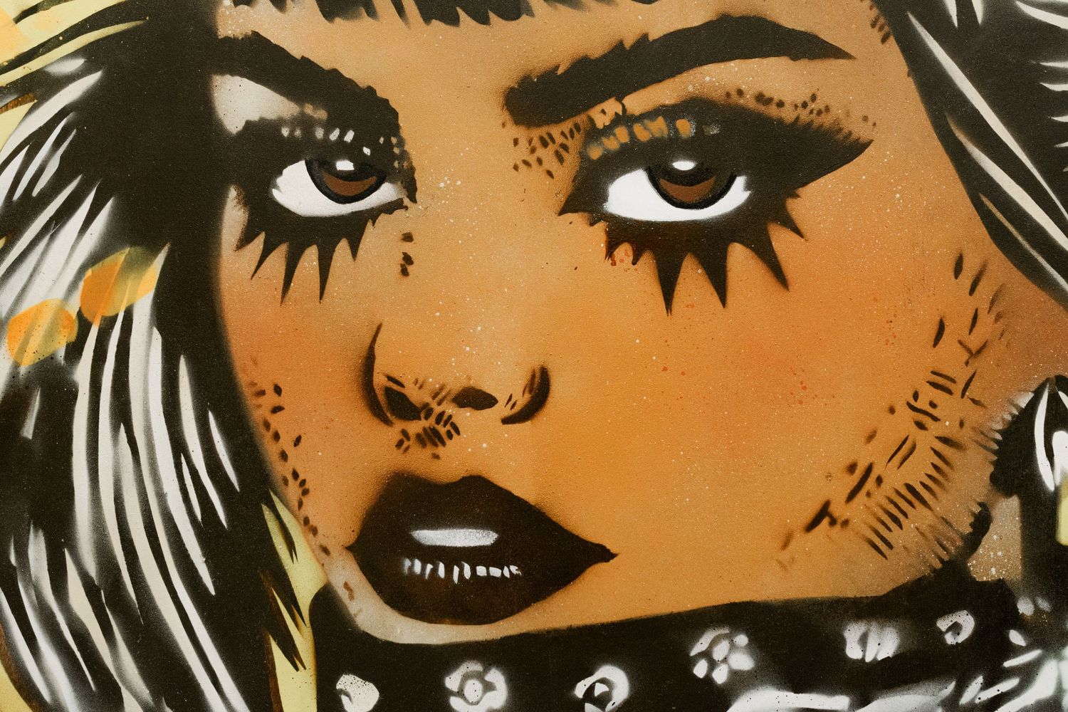 Close-up of bold street art portrait featuring a woman with dramatic makeup and bandana.