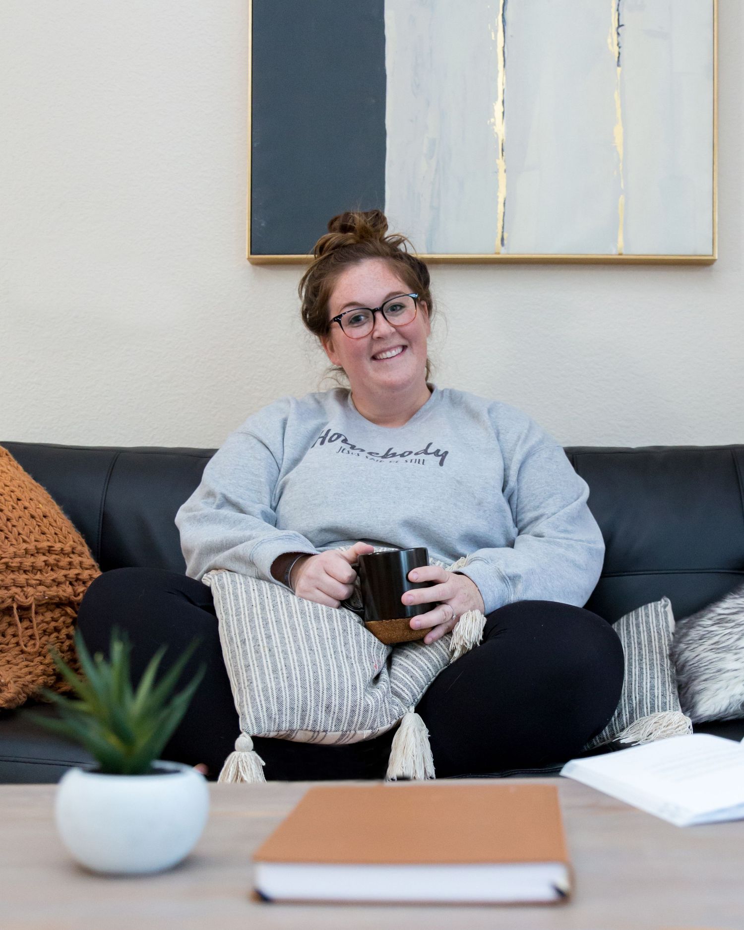 Woman sitting on couch dressed comfy with a cup of coffee by Vine Photography in Salem Ohio