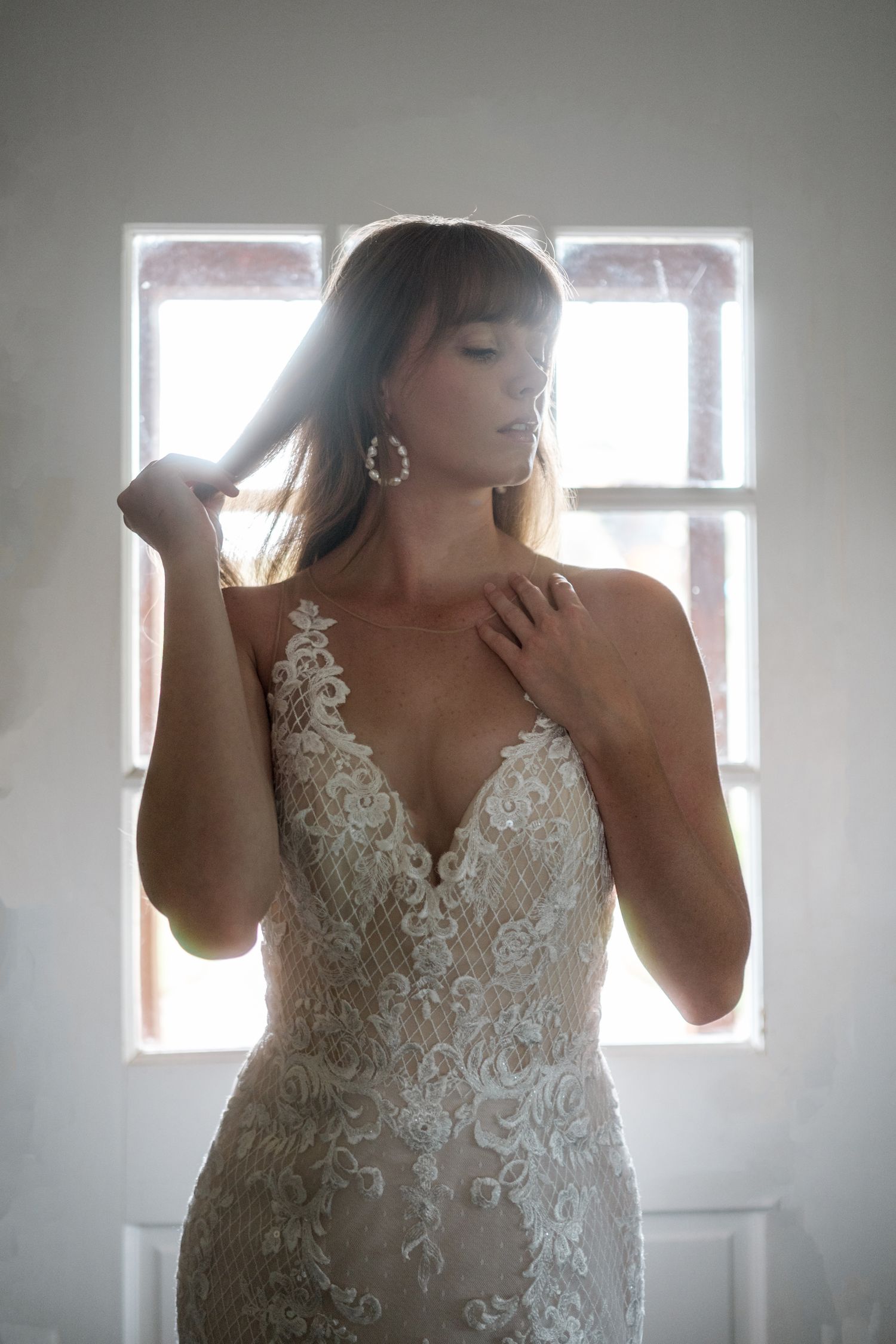 Ethereal bridal portraits with backlit windows creating a dreamy atmosphere.