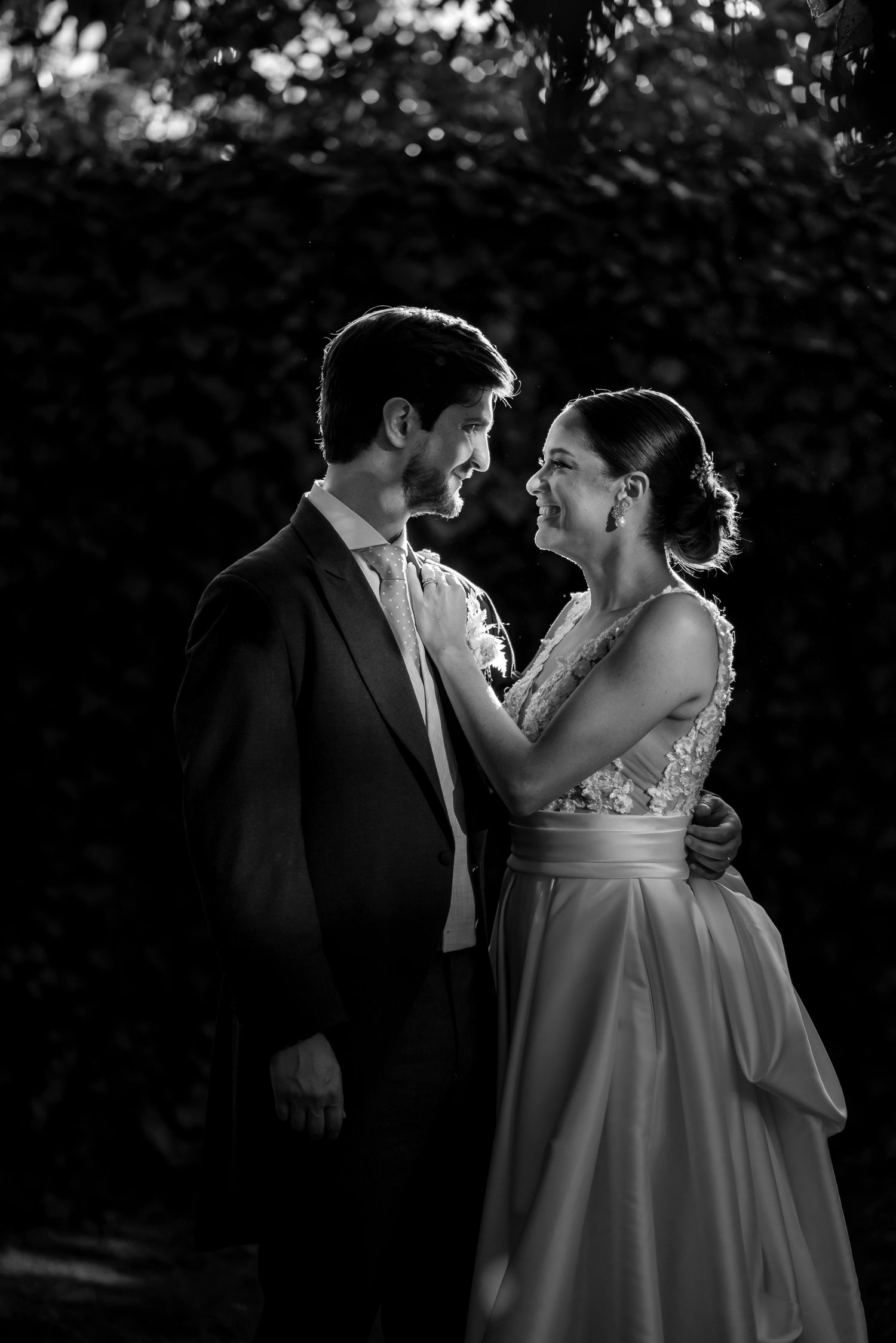 Romantic black and white portrait of couple in formal wedding attire.