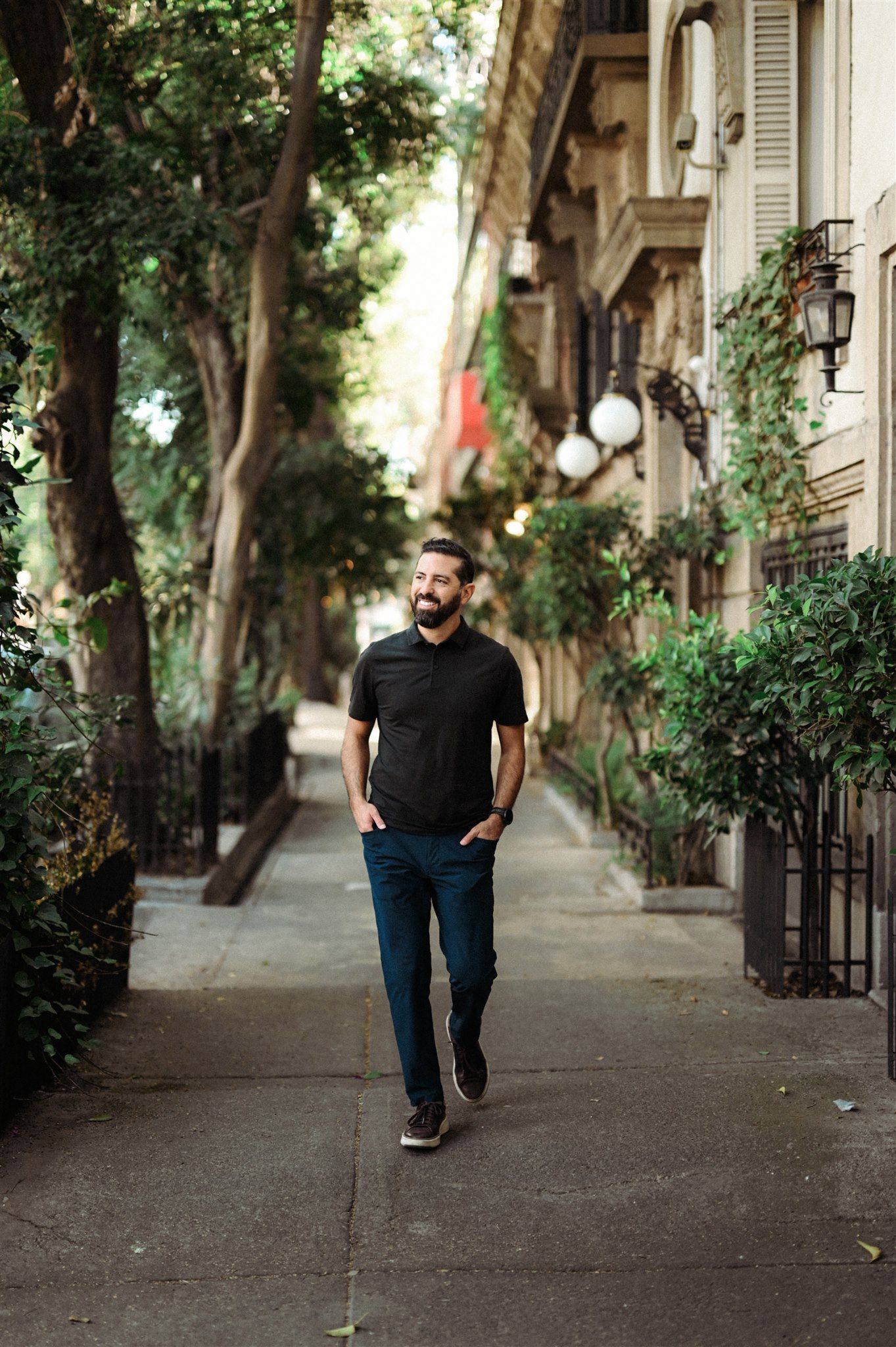 Casual portrait session on a tree-lined sidewalk with beautiful natural lighting.