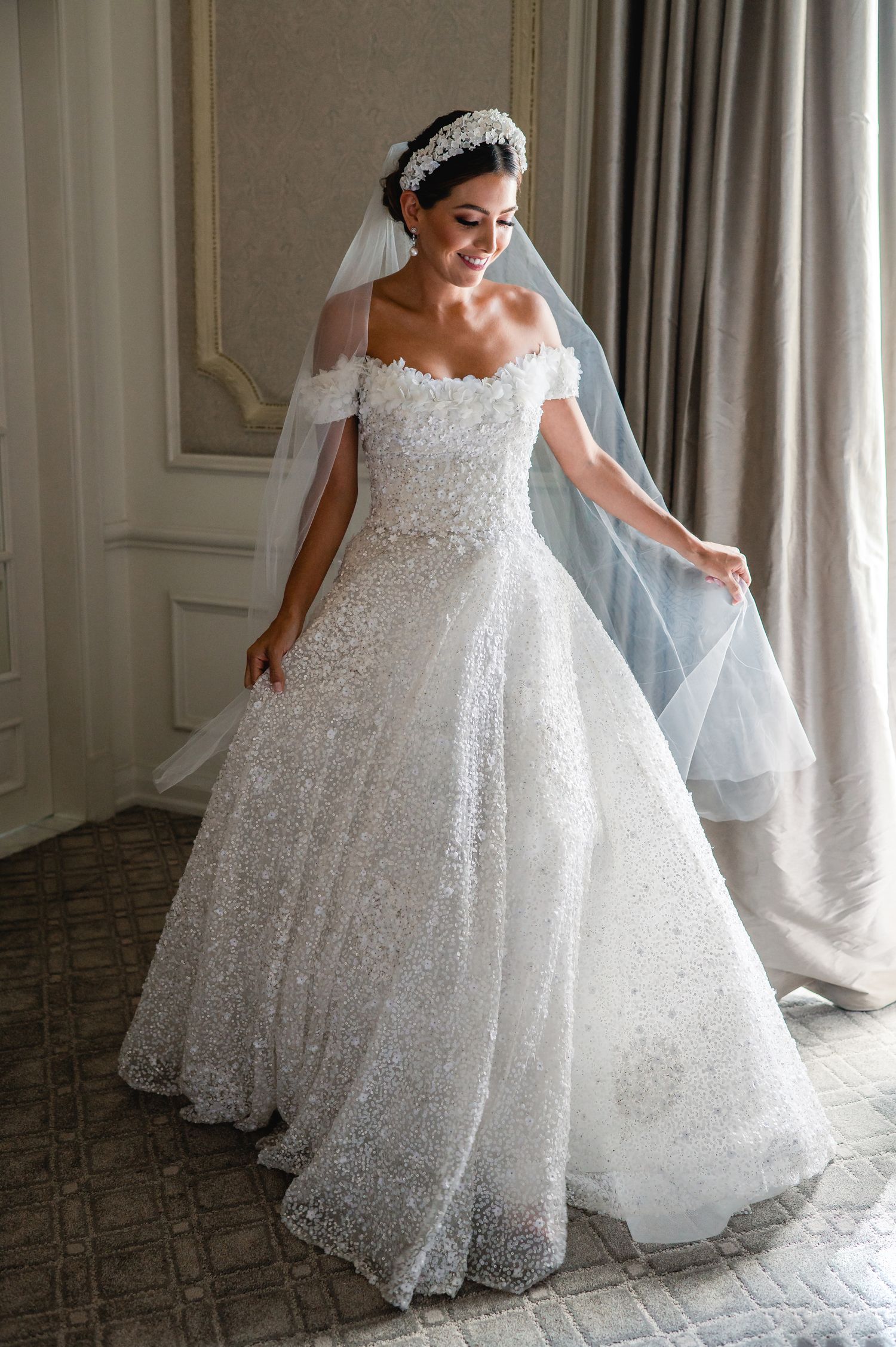 Sparkling white ballgown wedding dress with intricate lace details and full tulle skirt.