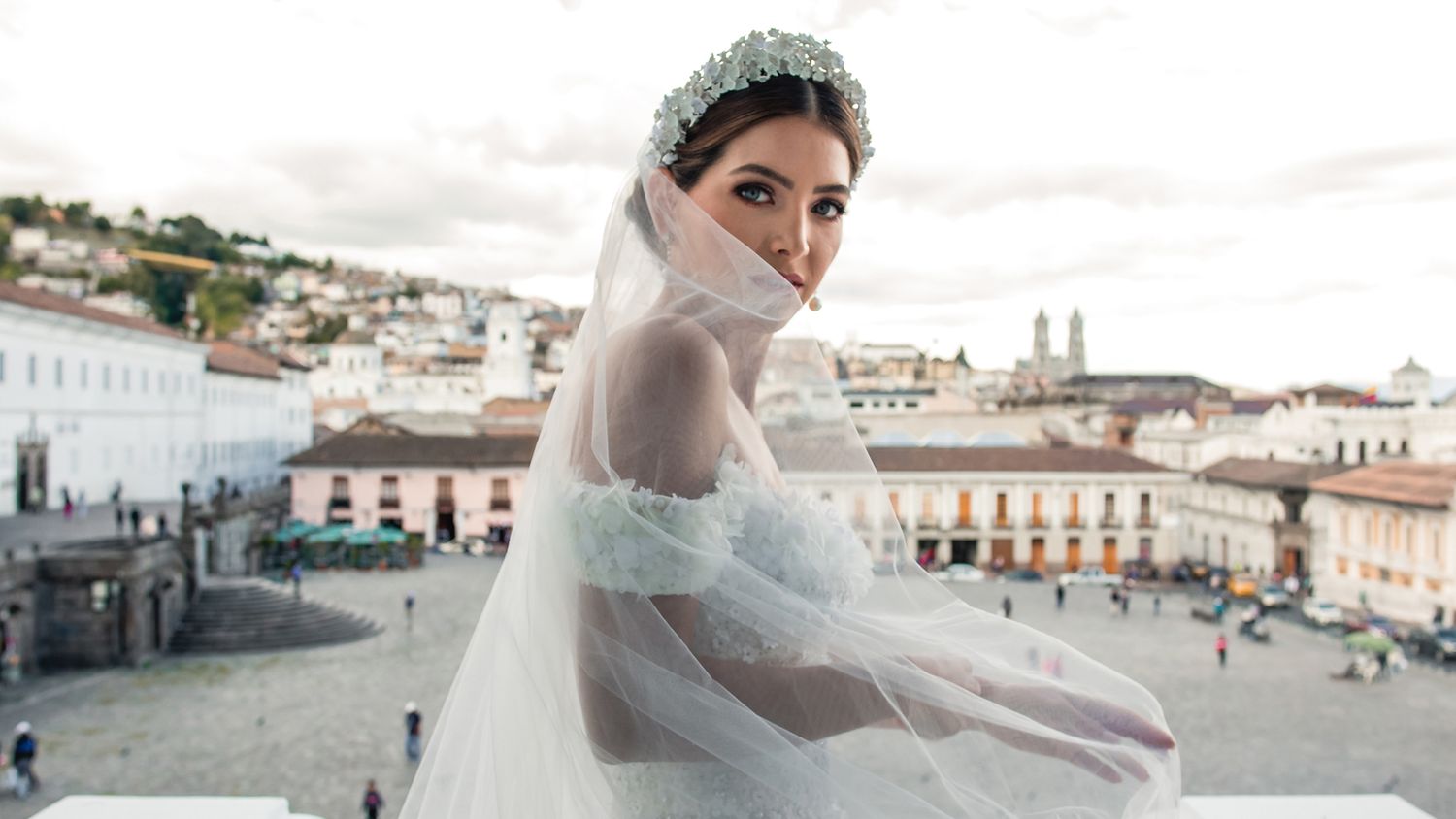 Scenic rooftop wedding photography with historic city buildings in background.