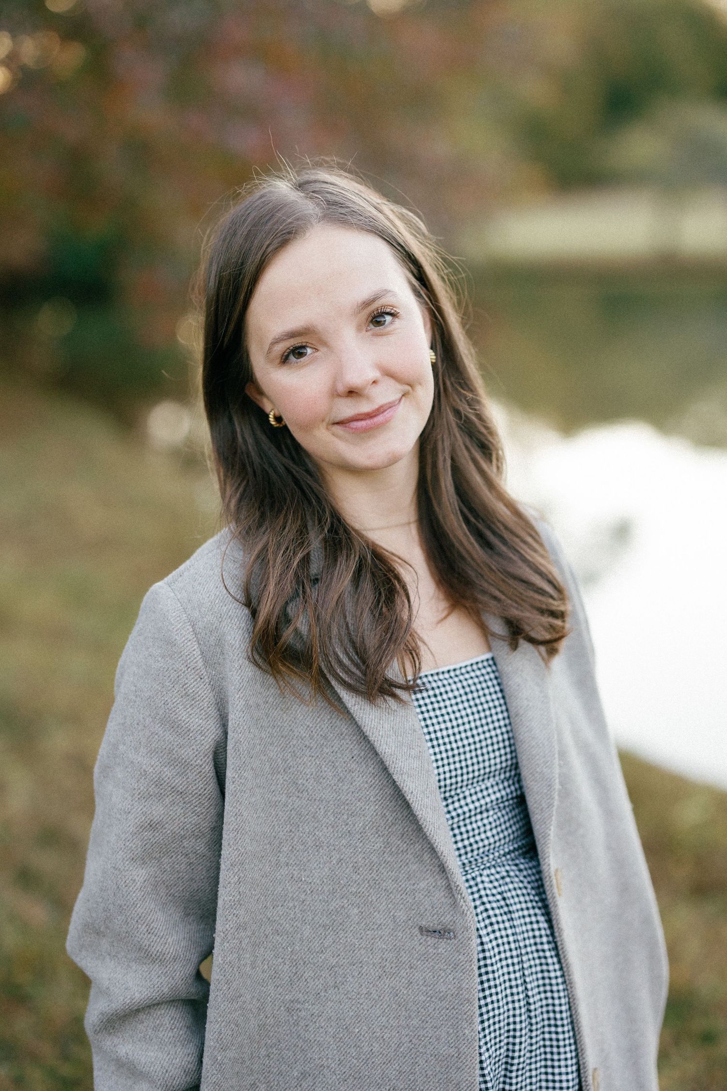 A series of portrait photos showing a person in a gray coat and checkered dress smiling against a blurred outdoor background.