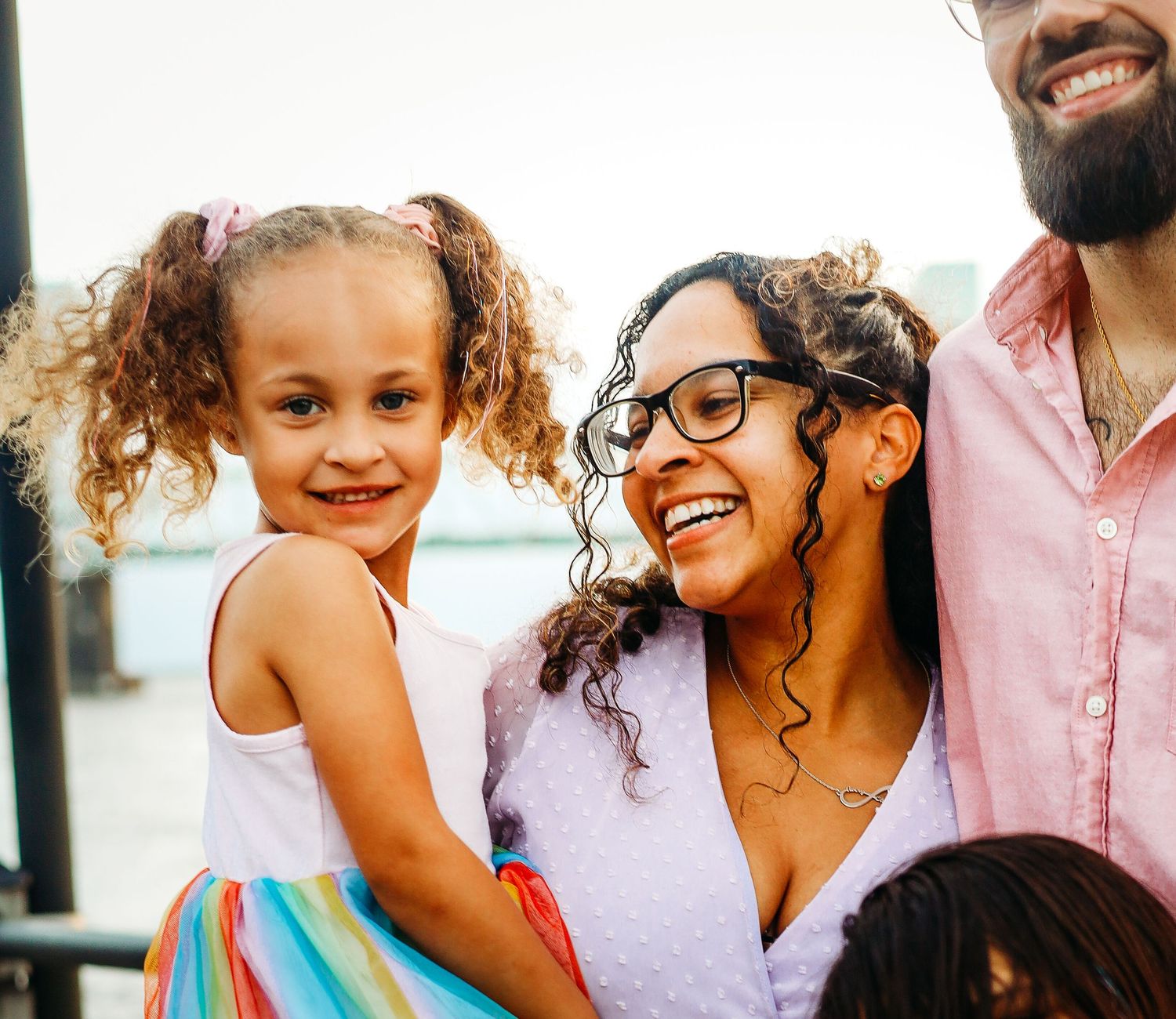 a mother smiles at her daughter gleefully