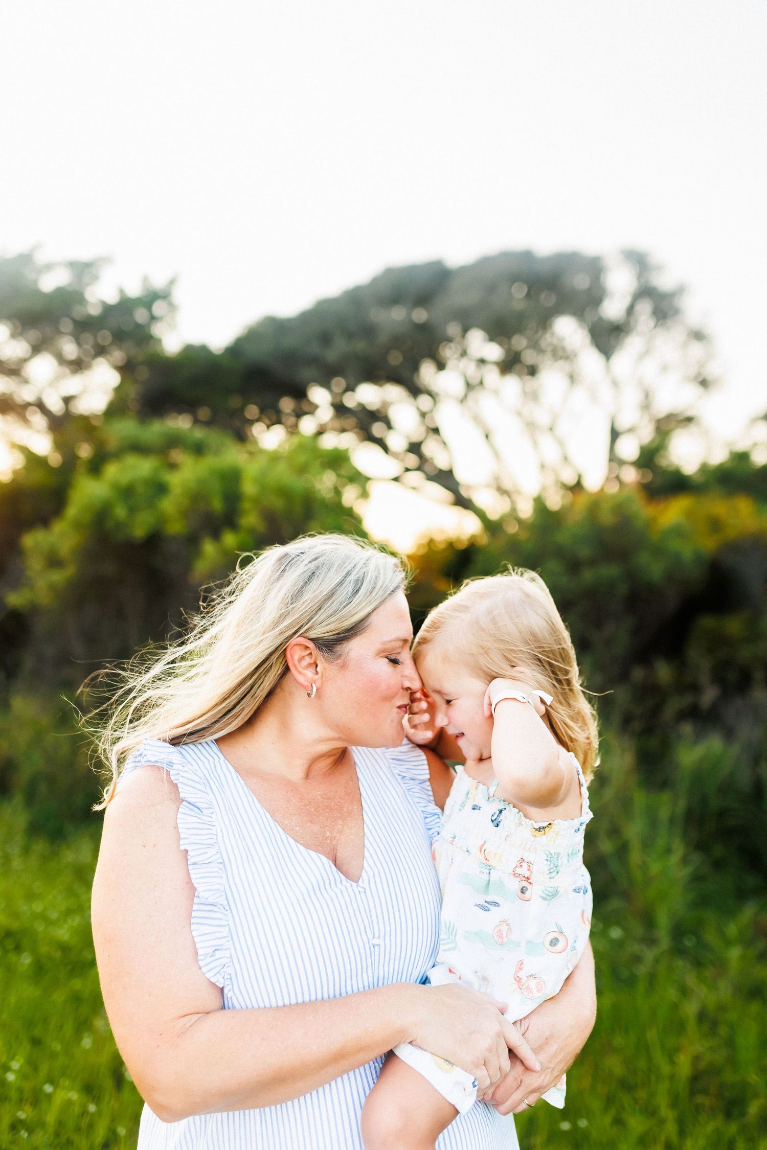a mother and her daughter nuzzle each other