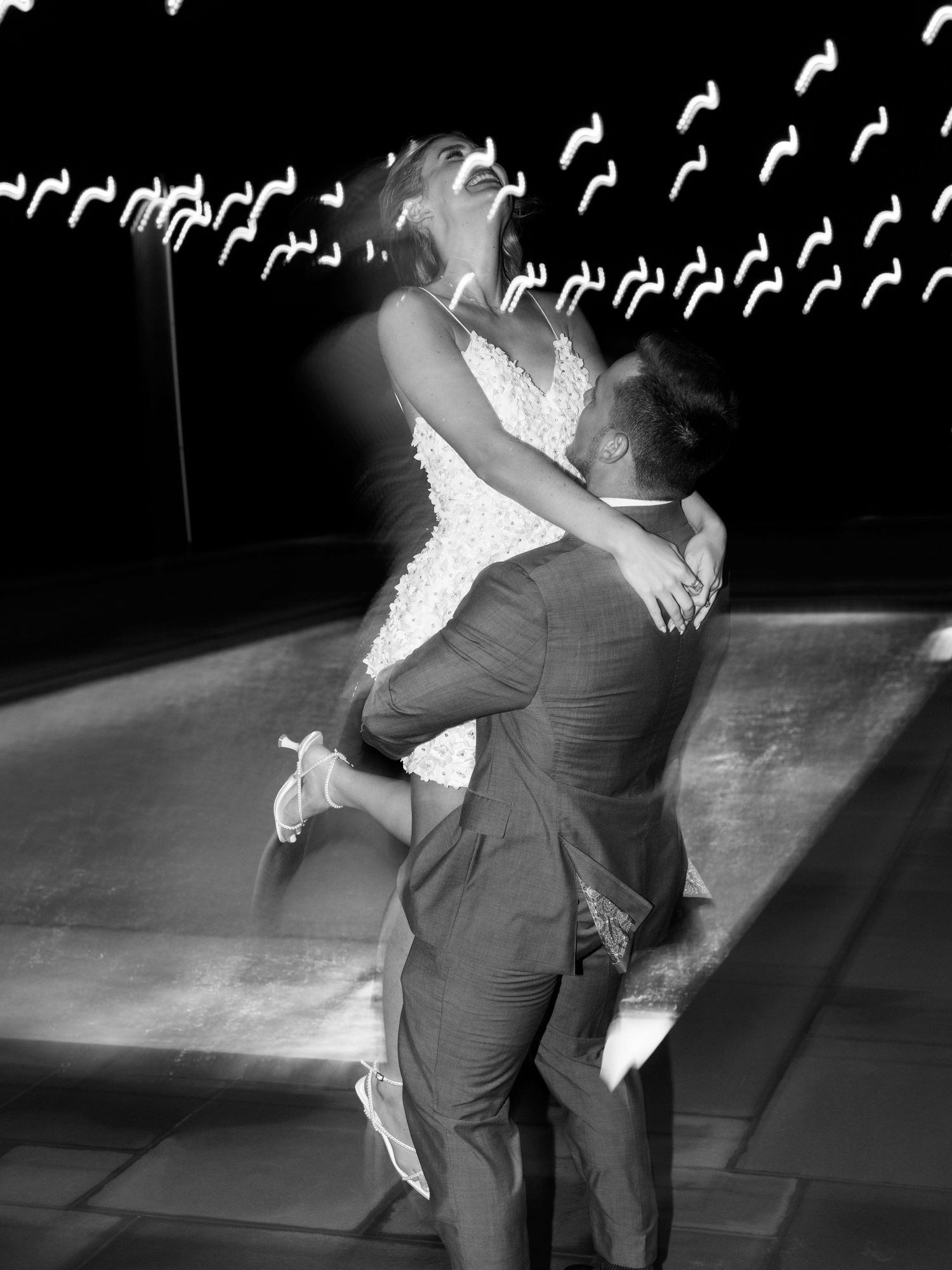 NJ couple dancing together in dramatic lighting with musical note decorations visible in the dark background.