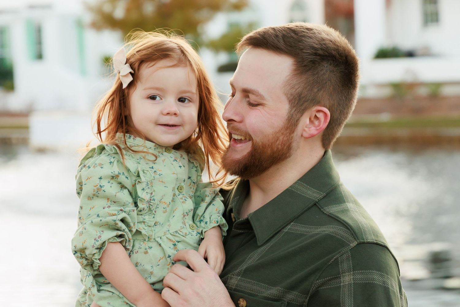 Sweet family moments captured by the water during a fall photoshoot.