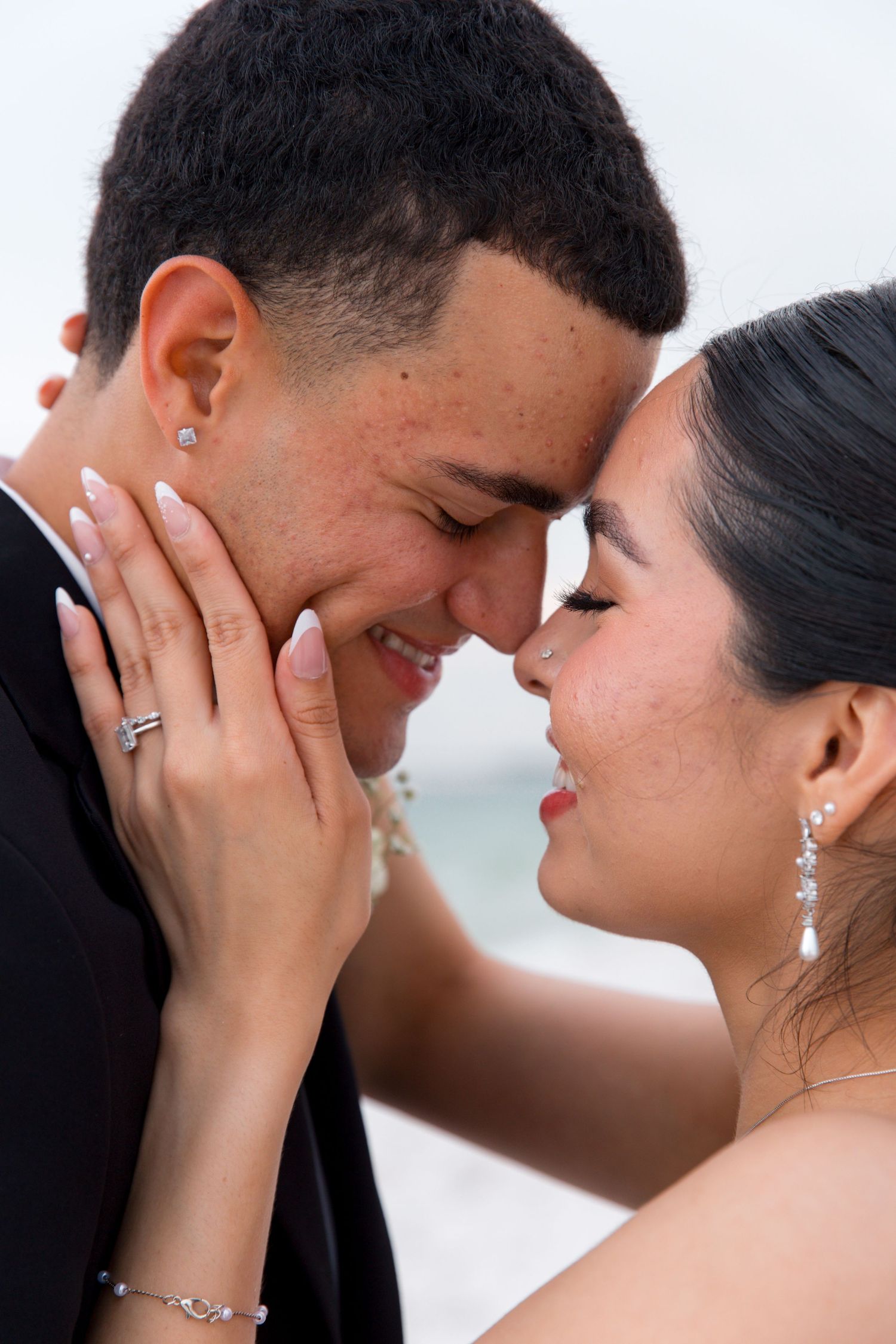 Close-up of tender moment between newlyweds showing genuine emotion.