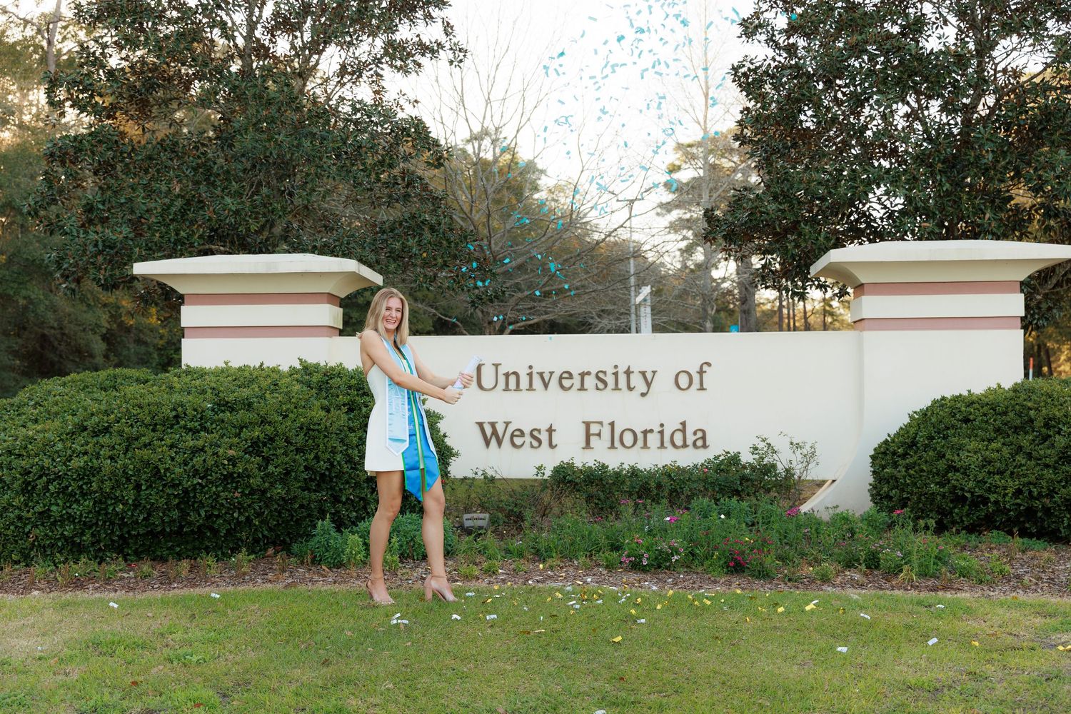 A panoramic collage showing six connected views of a white University of West Florida entrance sign and landscaping.