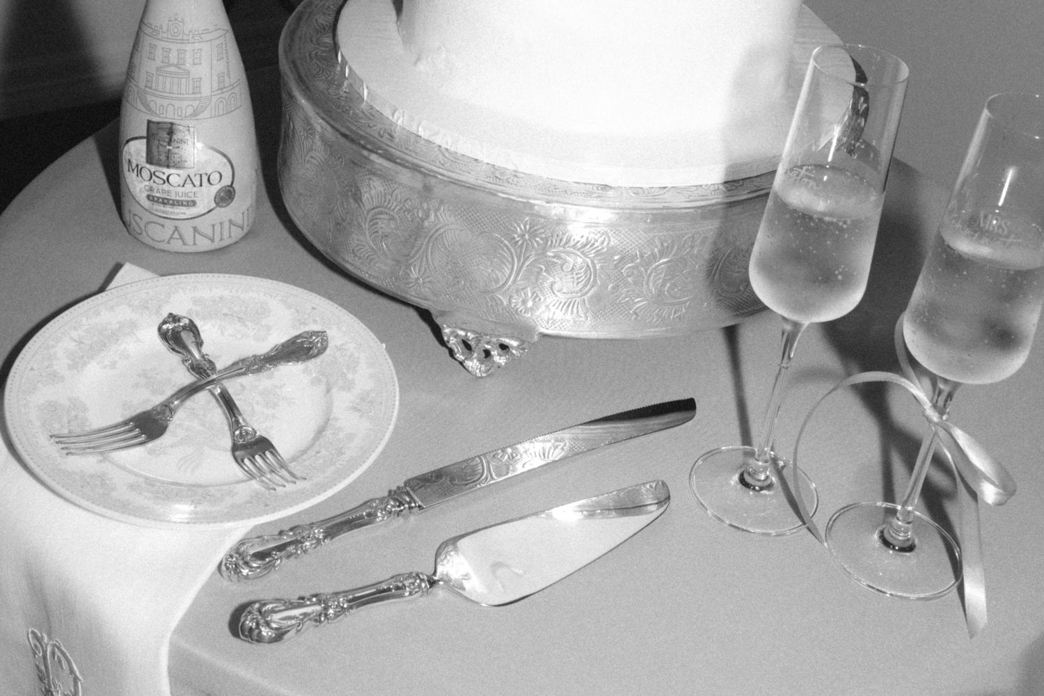 Compilation of black and white photos showing dining tables set with plates, glasses, and silverware in a formal setting.