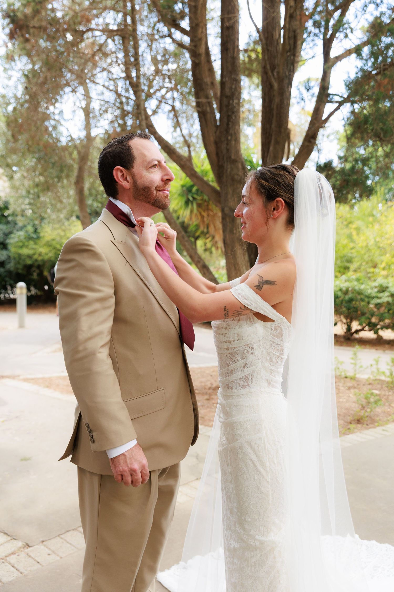 A bride and groom share a joyful moment together during their outdoor wedding ceremony.